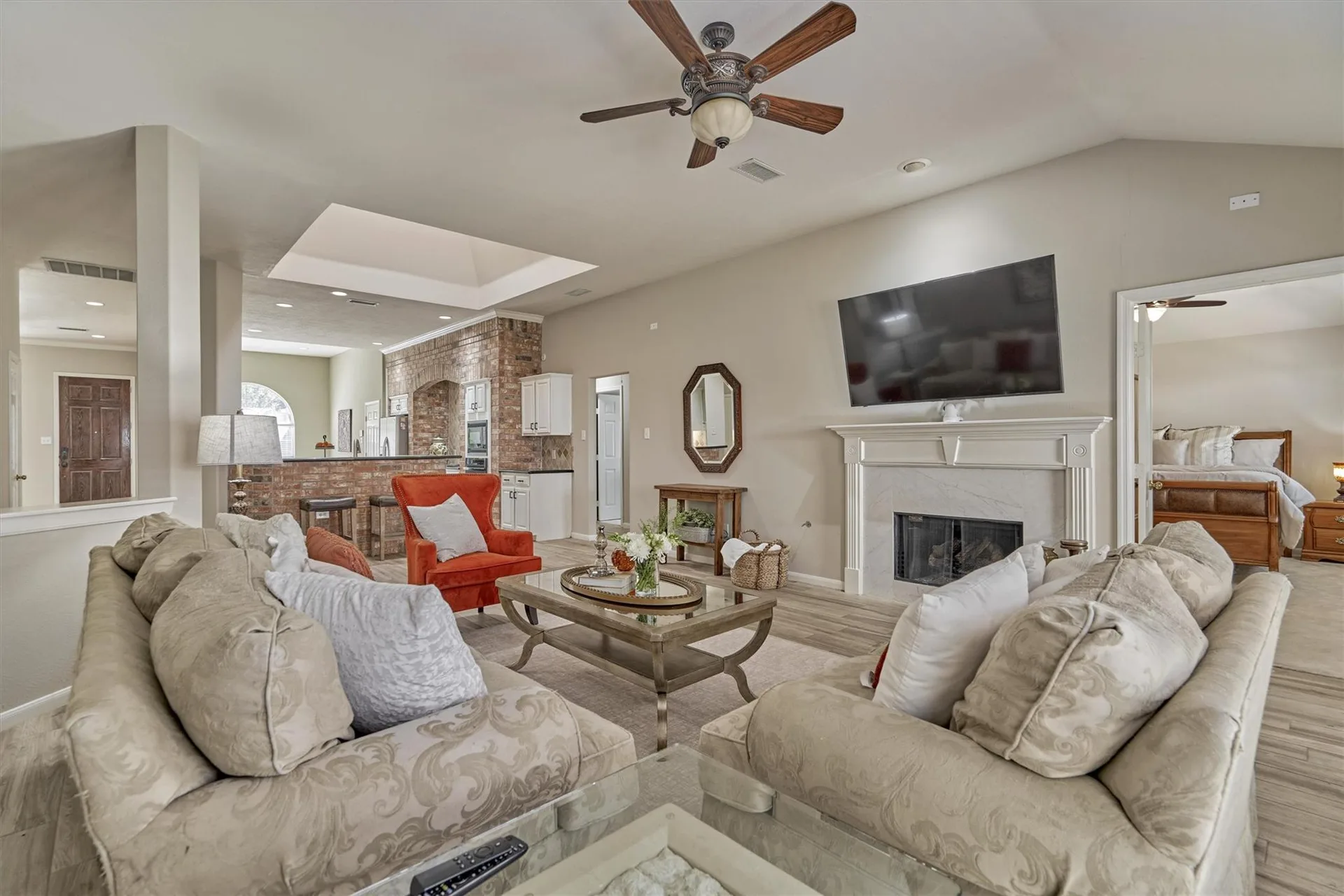 Living room with vaulted ceilings, fireplace, brick wall detail