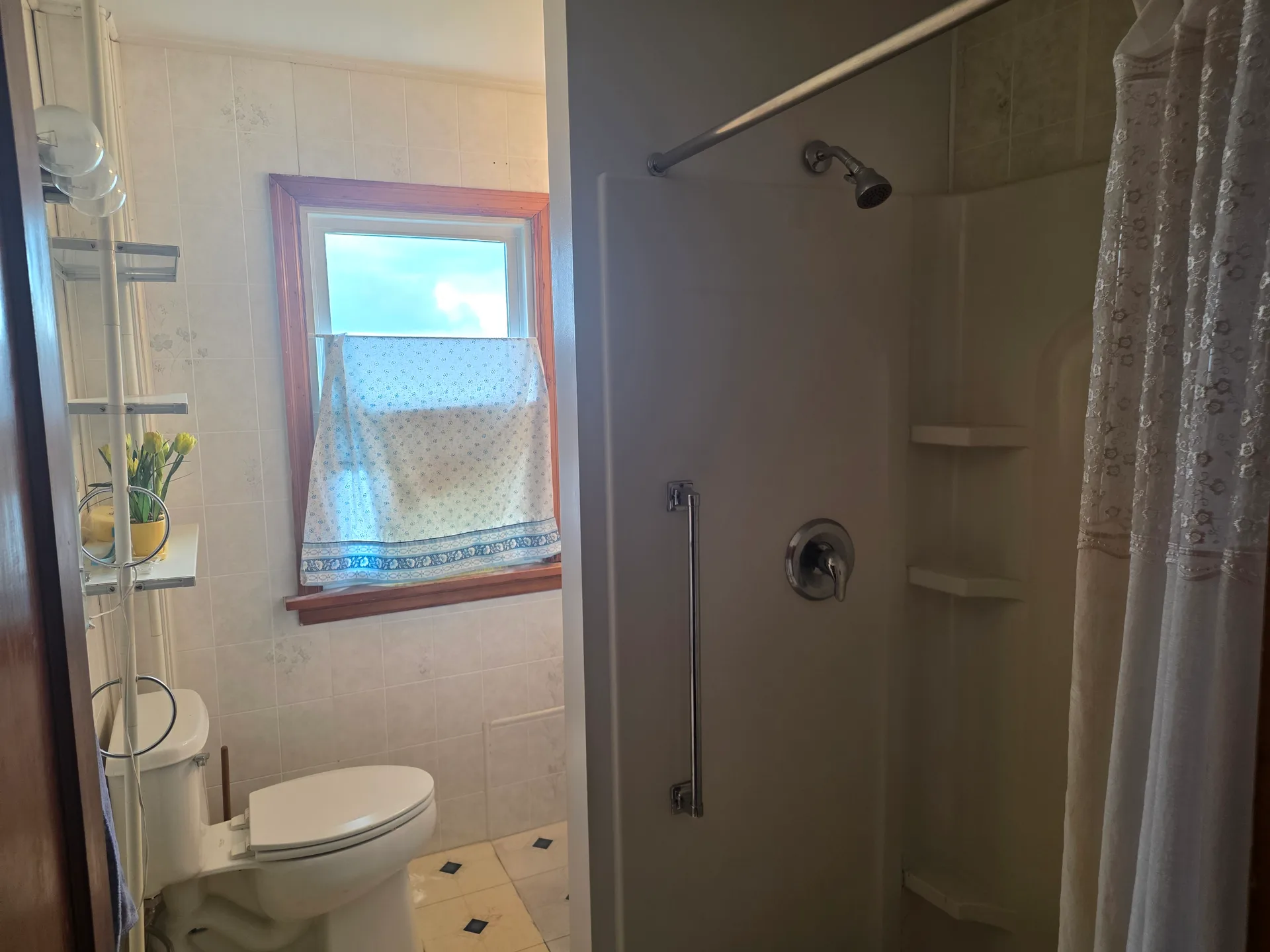 Full bathroom with tiled walls and shower
