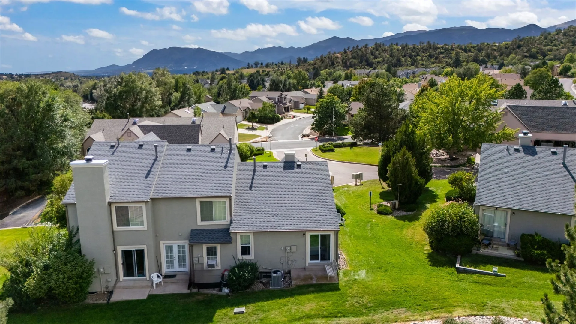 Aerial view of 2552 Blazek Loop and the surrounding townhome neighborhood with the Front Range in the distance