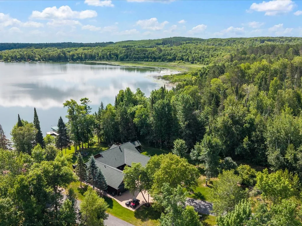 Aerial of the estate nestled in mature trees beside Mitchell Lake