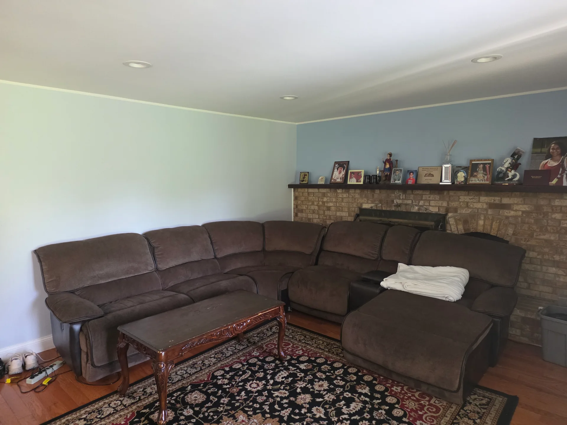 First-floor family room with a brick wood-burning fireplace at 4420 Phillip Street