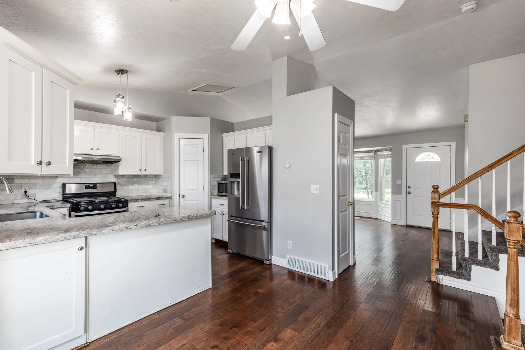 Open-concept kitchen with view to entryway
