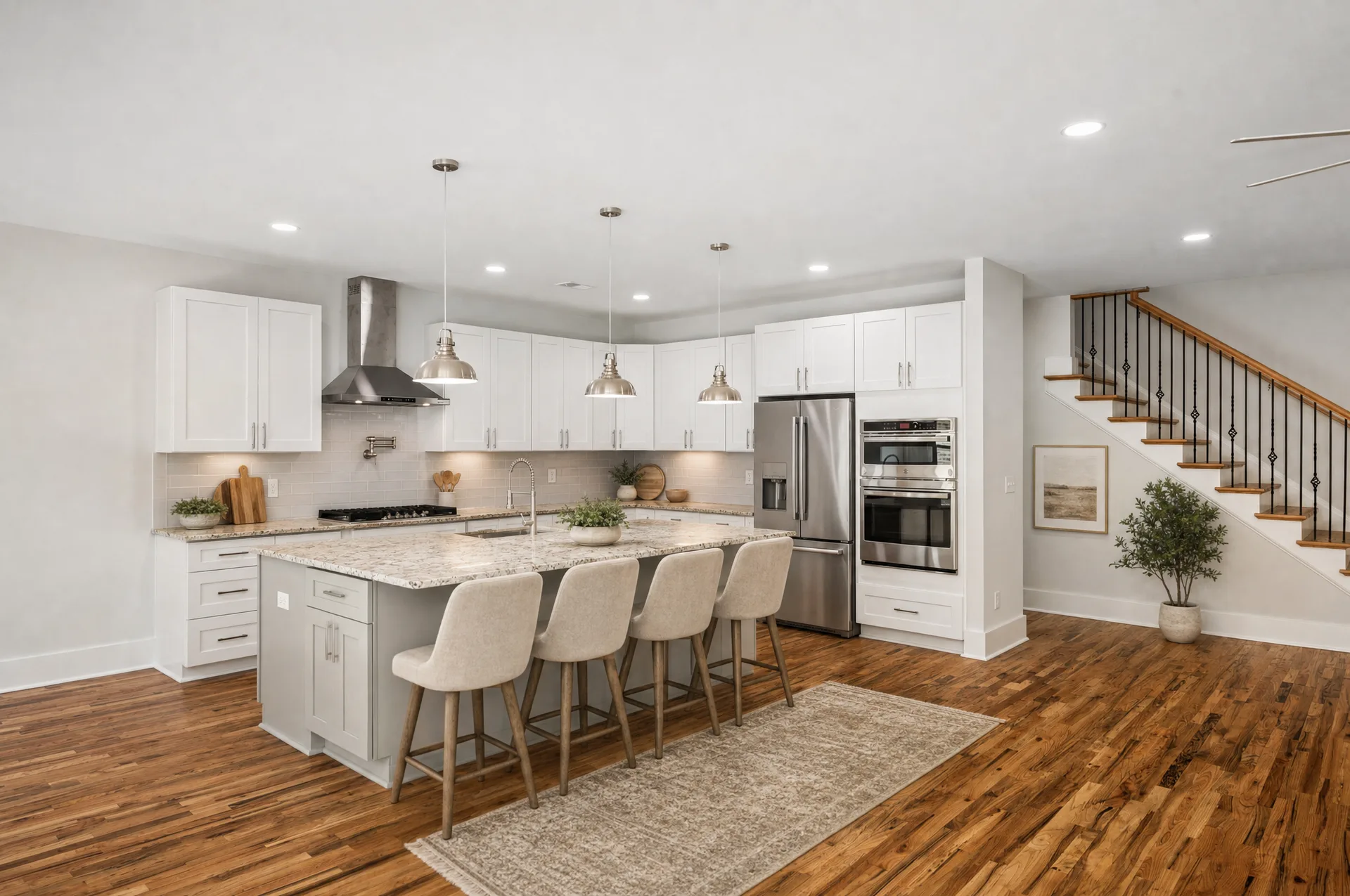 Kitchen with island seating beside the staircase