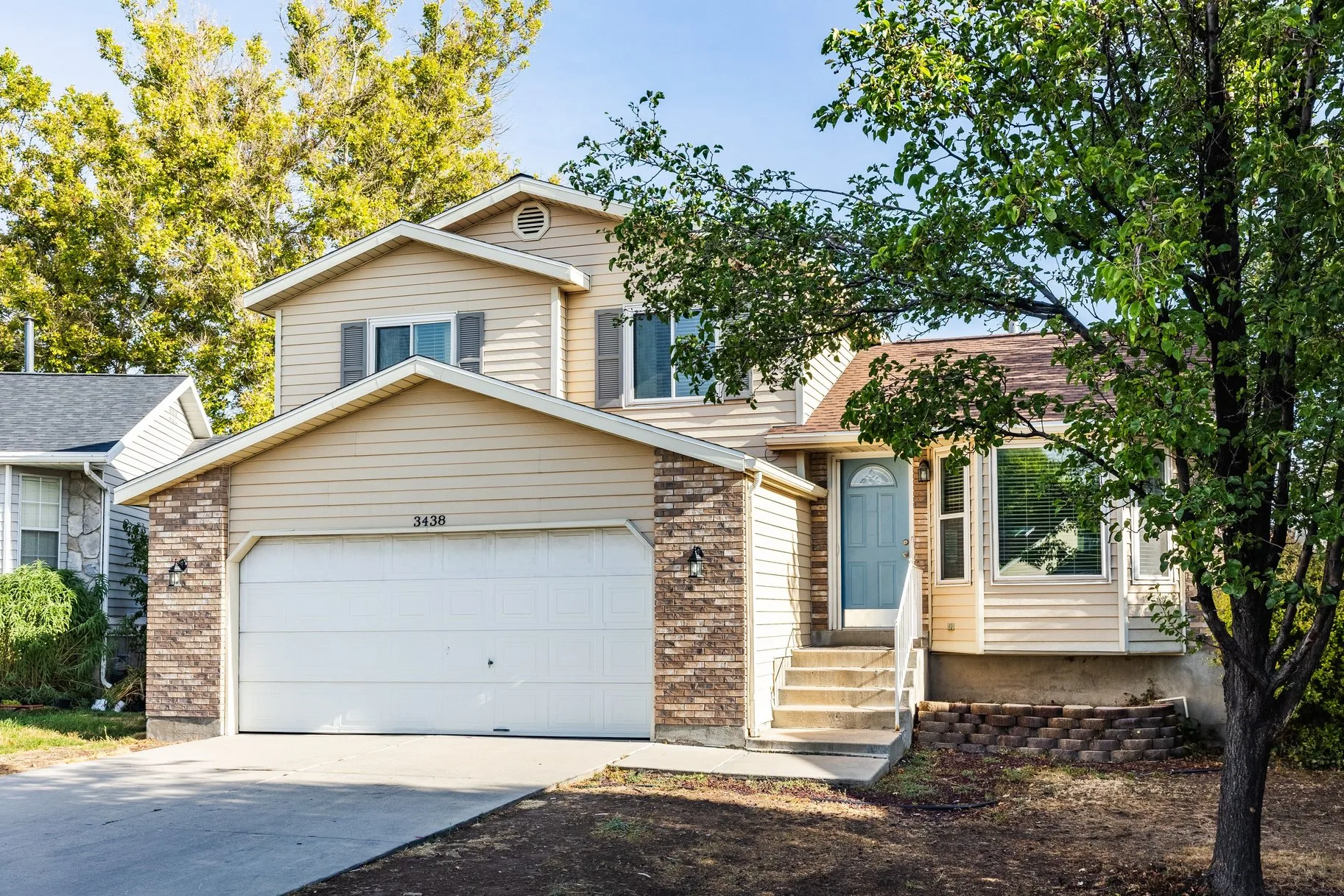 Front exterior showing landscaping and attached garage