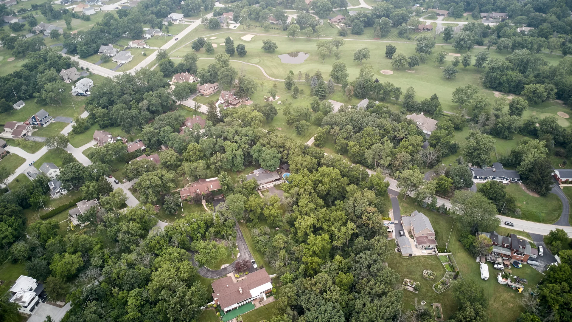 Aerial view of the Crete, Illinois neighborhood near 3708 Cooper Place with a nearby golf course