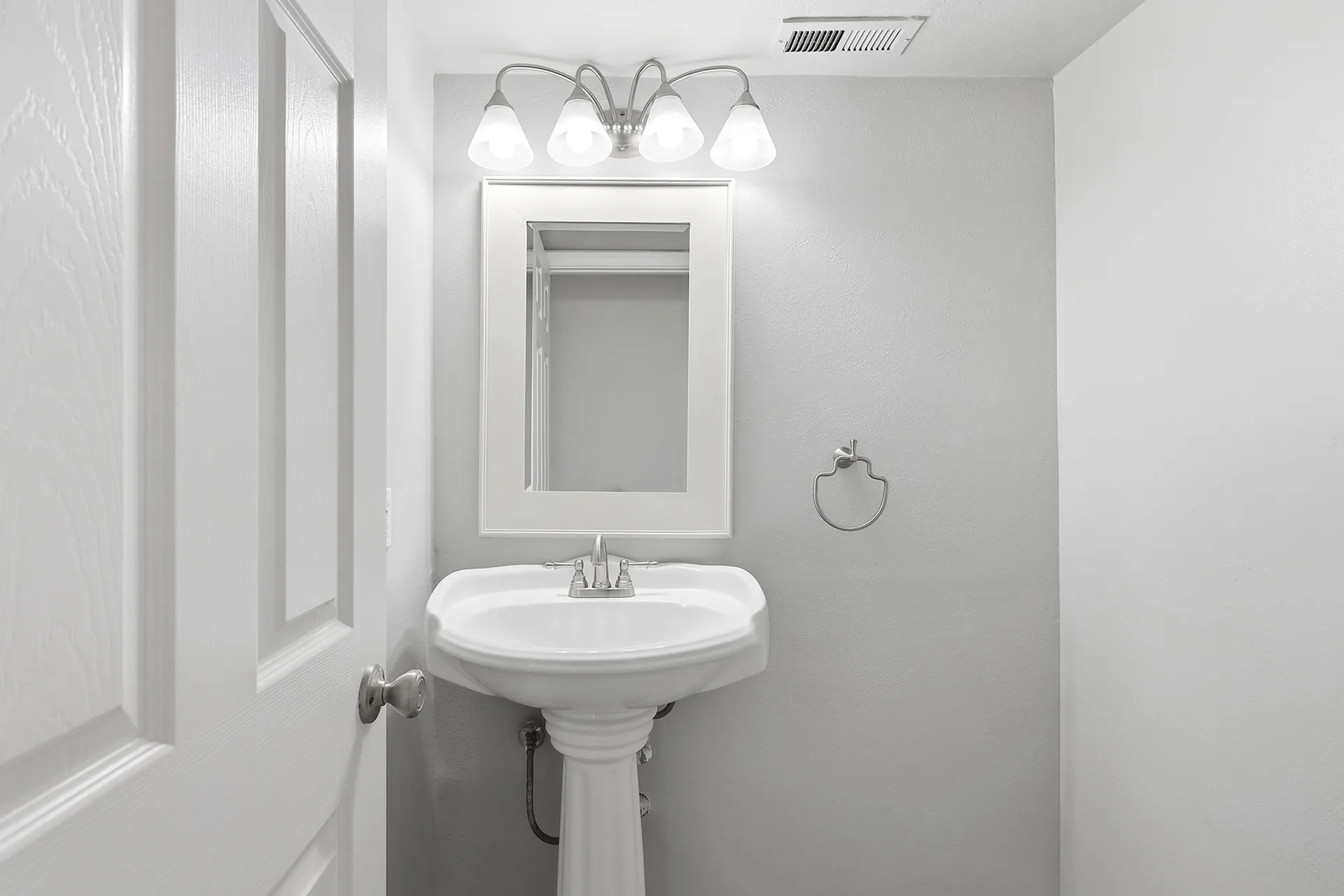 Powder room at 8 Silverwood with grey walls, a pedestal sink, and a four-bulb vanity light