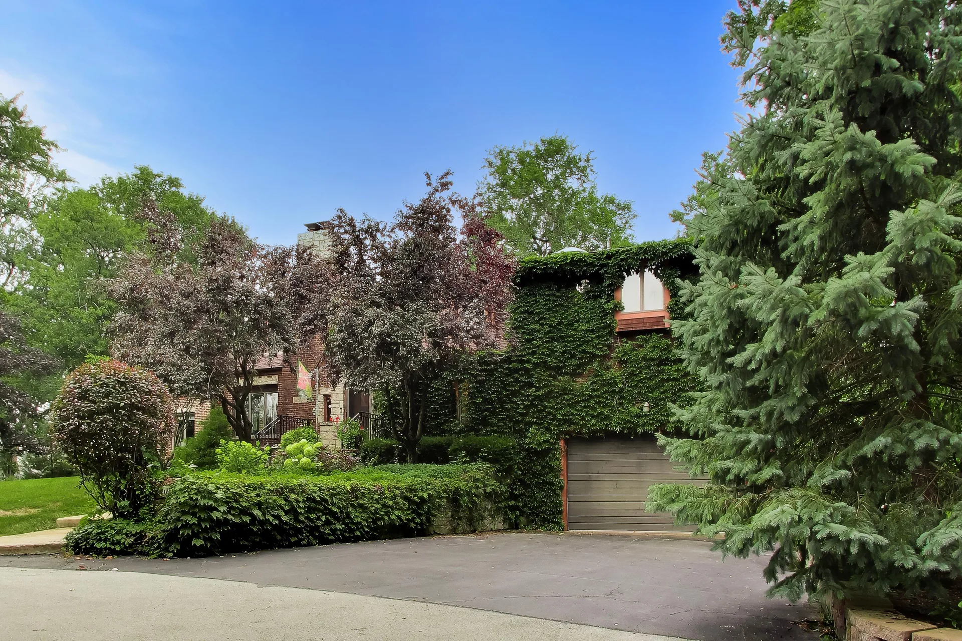 Ivy-covered brick and stone facade of the house