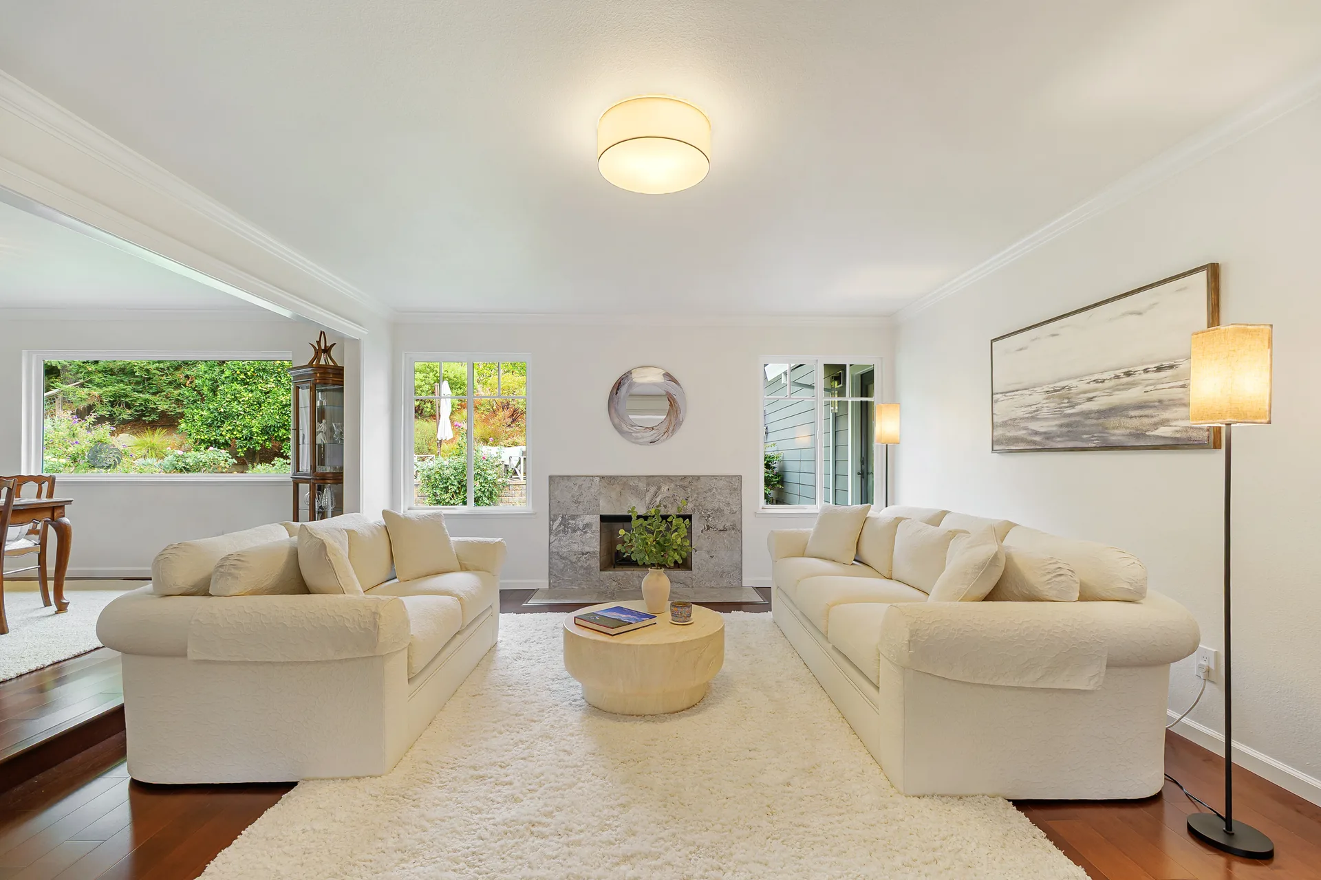 Living room with marble fireplace surround and maple engineered hardwood flooring