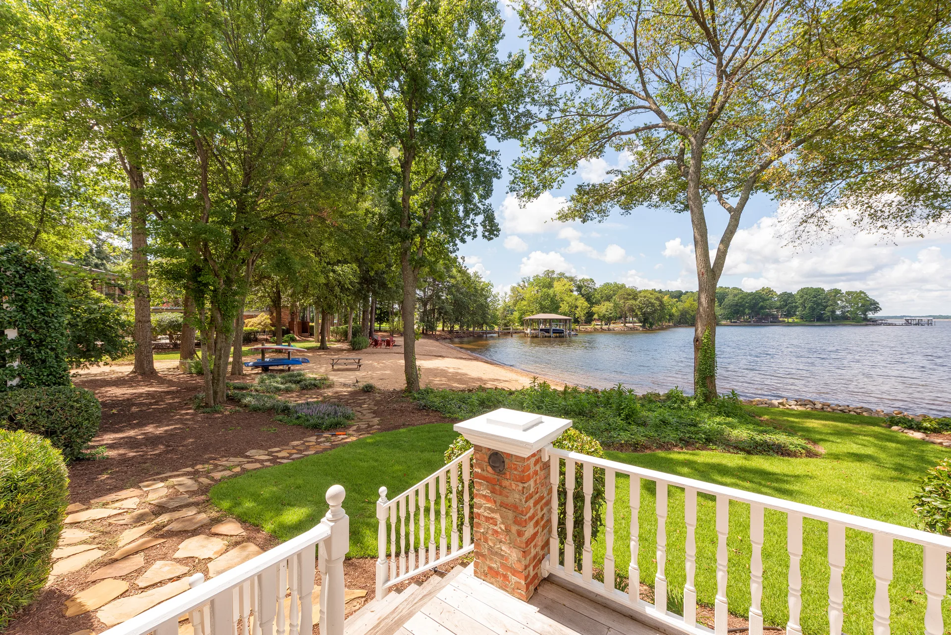 Backyard with sandy beach and stone pathway