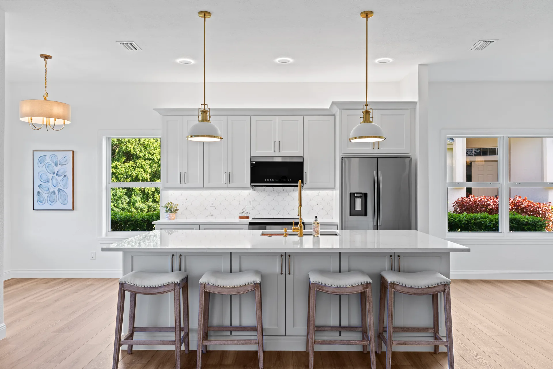 White shaker cabinetry with quartz countertops and patterned tile backsplash