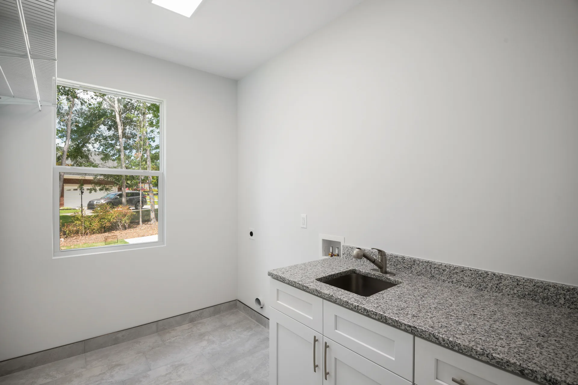 Laundry and utility room with granite counter