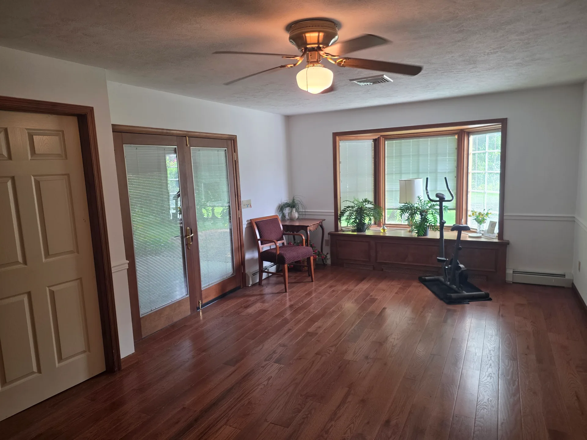 Second bedroom or den with bay window and built-in window seat