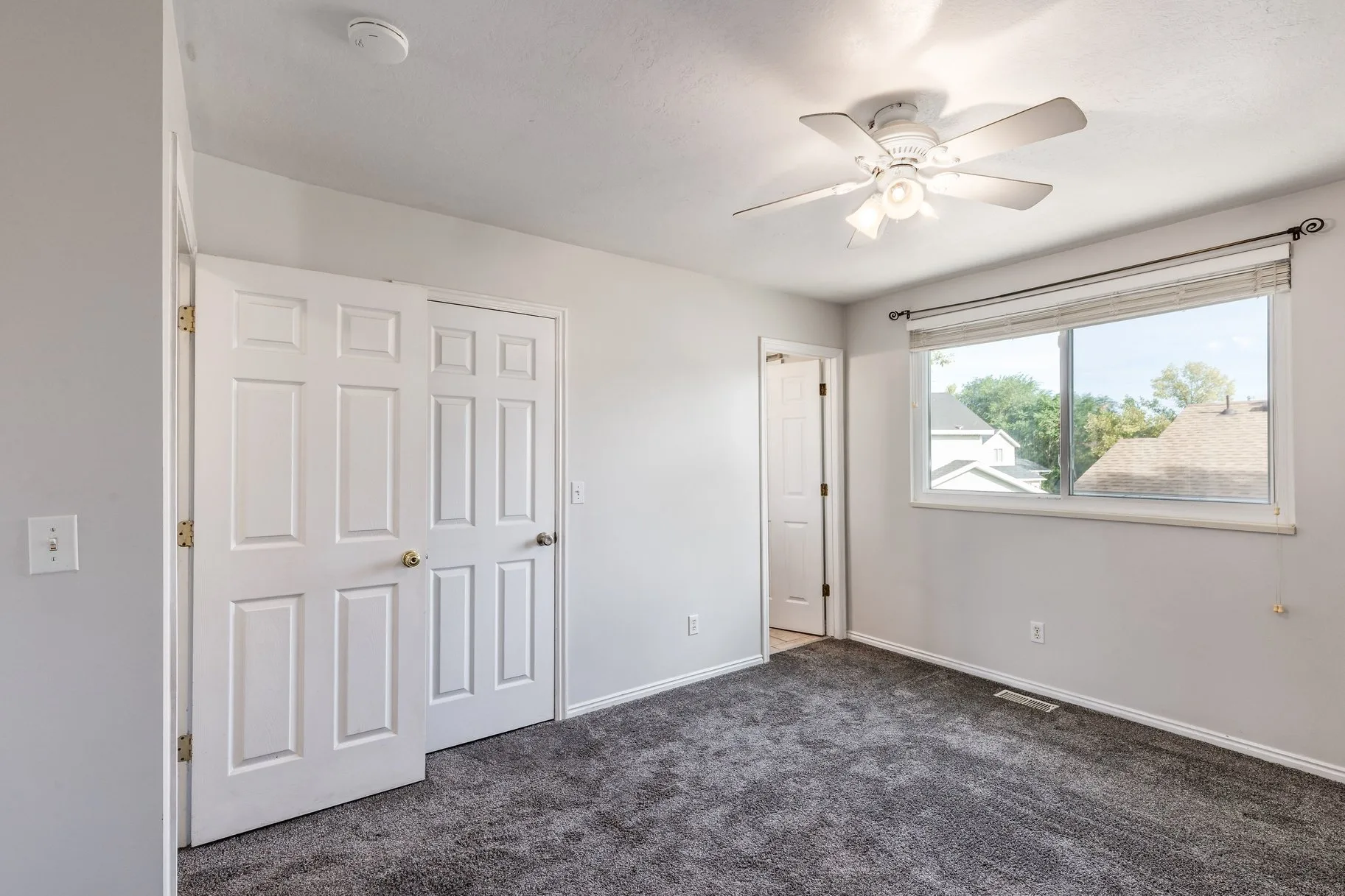 Vacant secondary bedroom with natural daylight