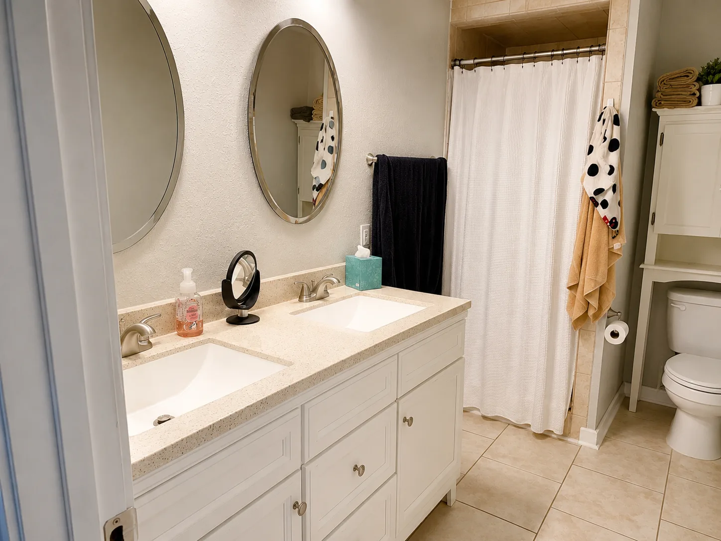 Primary bathroom vanity with mirrors