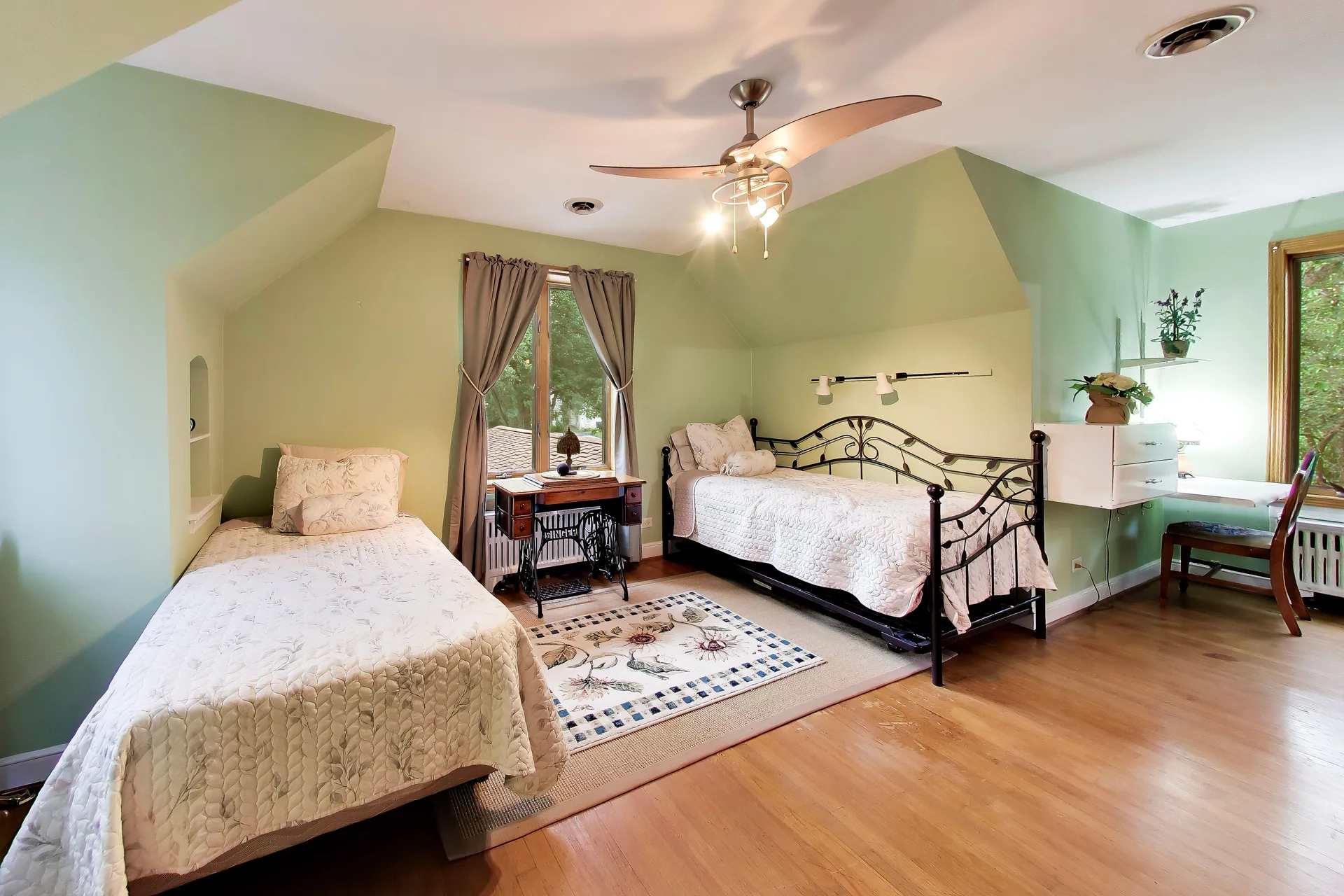Guest bedroom with sloped ceiling and sage green walls