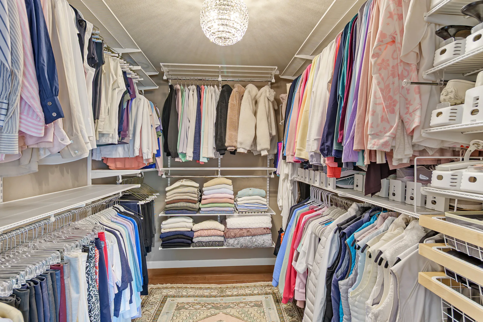 Walk-in closet with white wire shelving systems