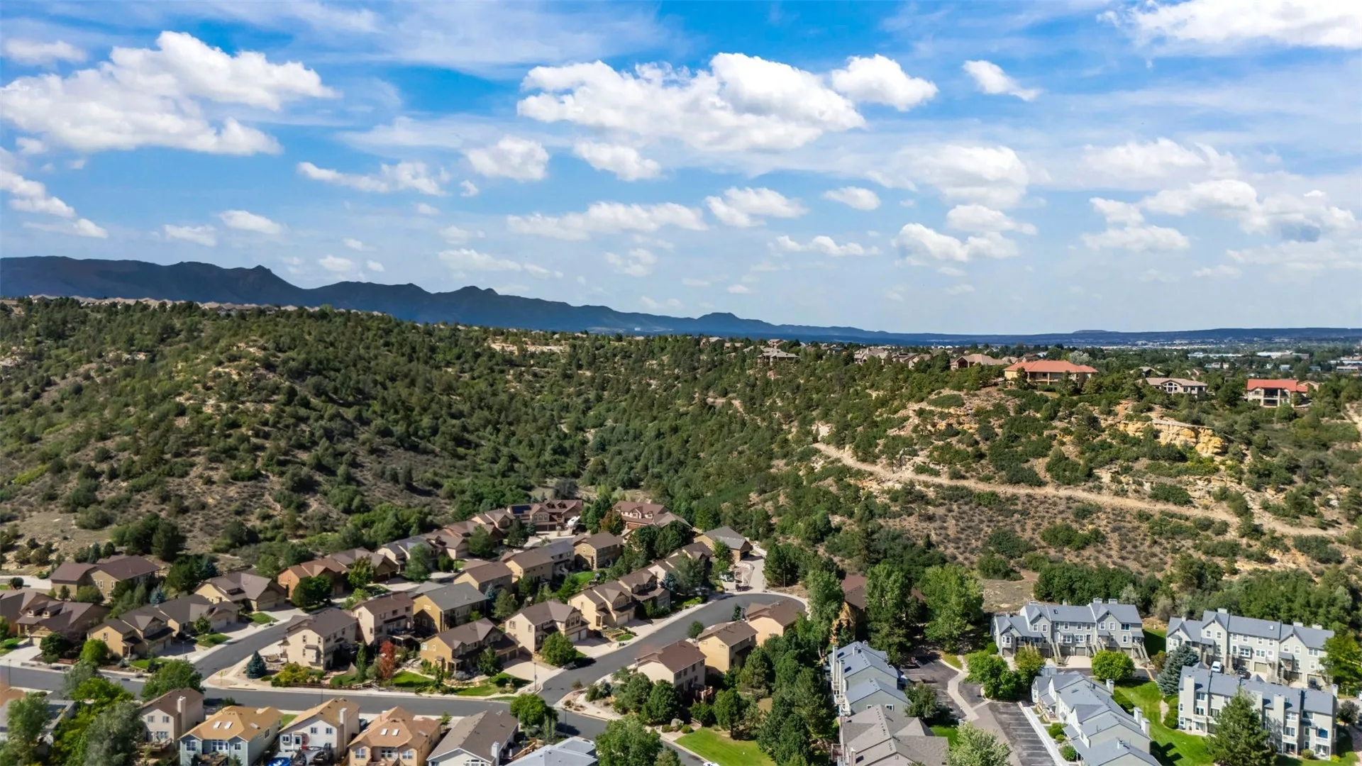 Aerial view of the neighborhood with mountain foothills in the background