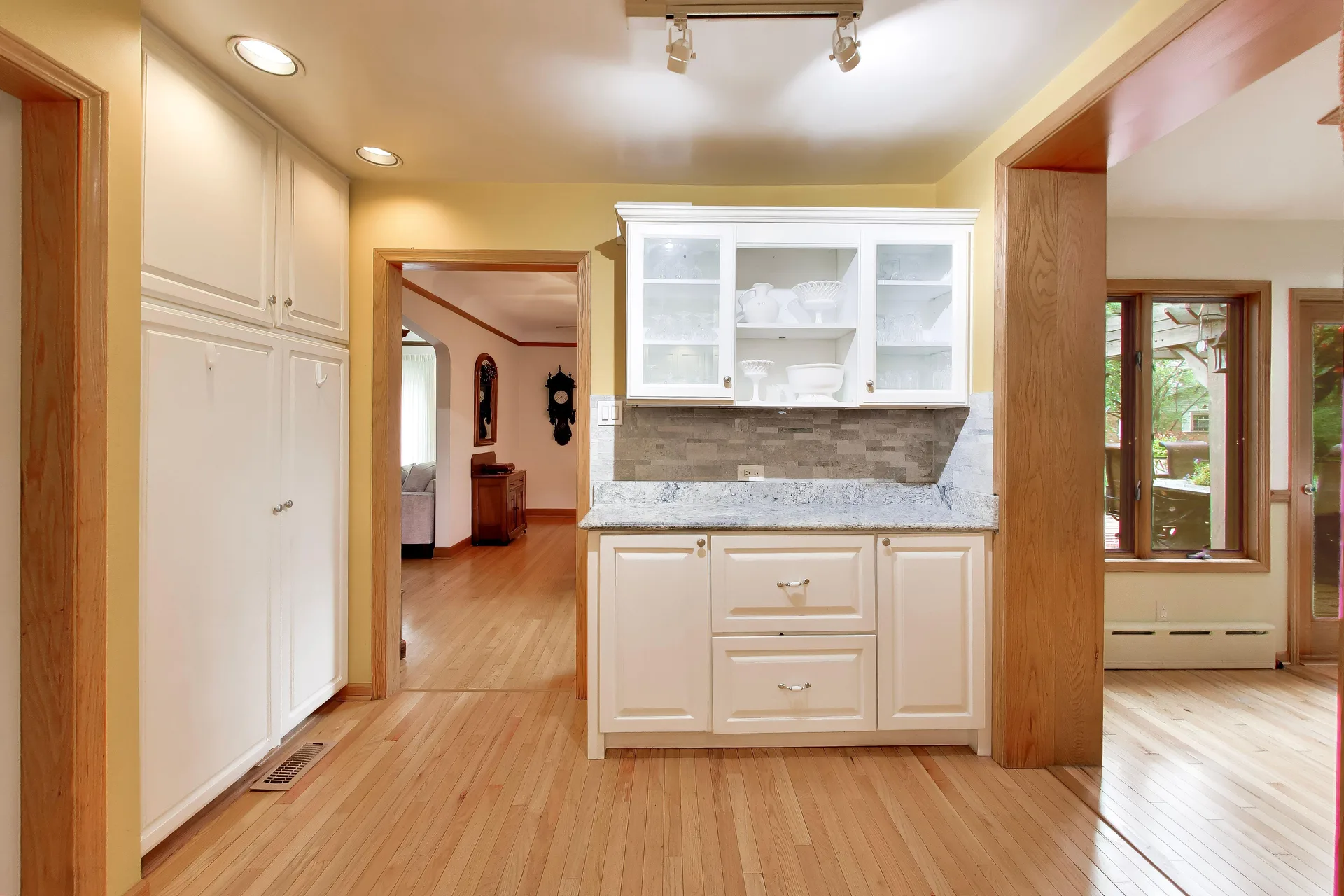 Built-in cabinetry and stone-look backsplash in the kitchen