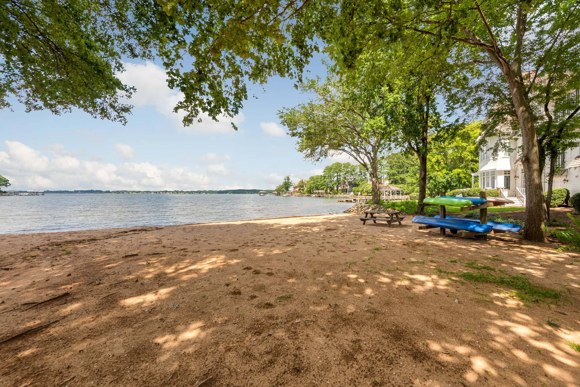 Private sandy lakeside beach with kayaks