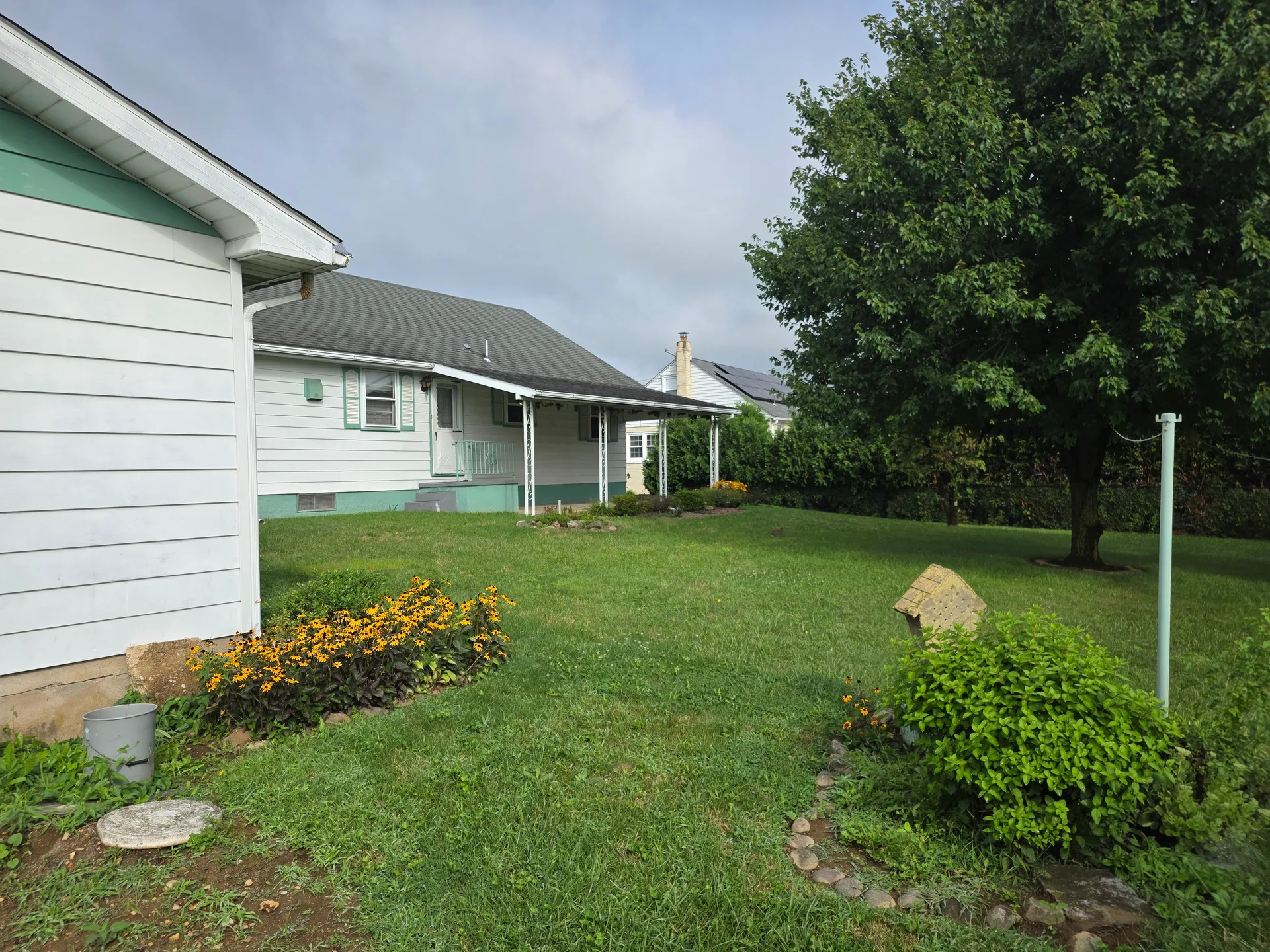 Spacious backyard with mature trees