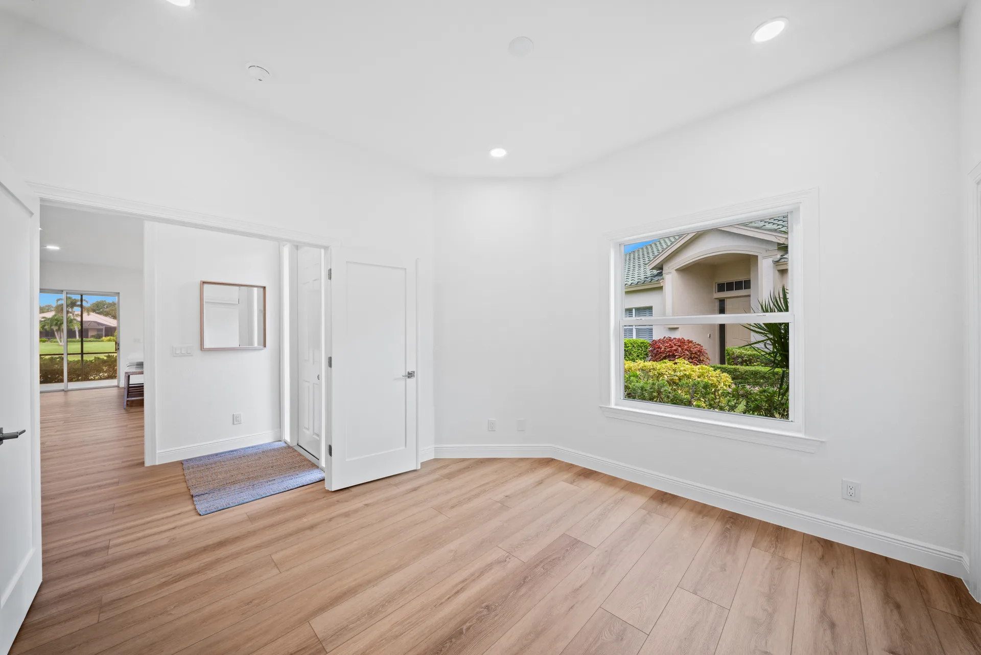 Bedroom looking toward entryway with lake view beyond