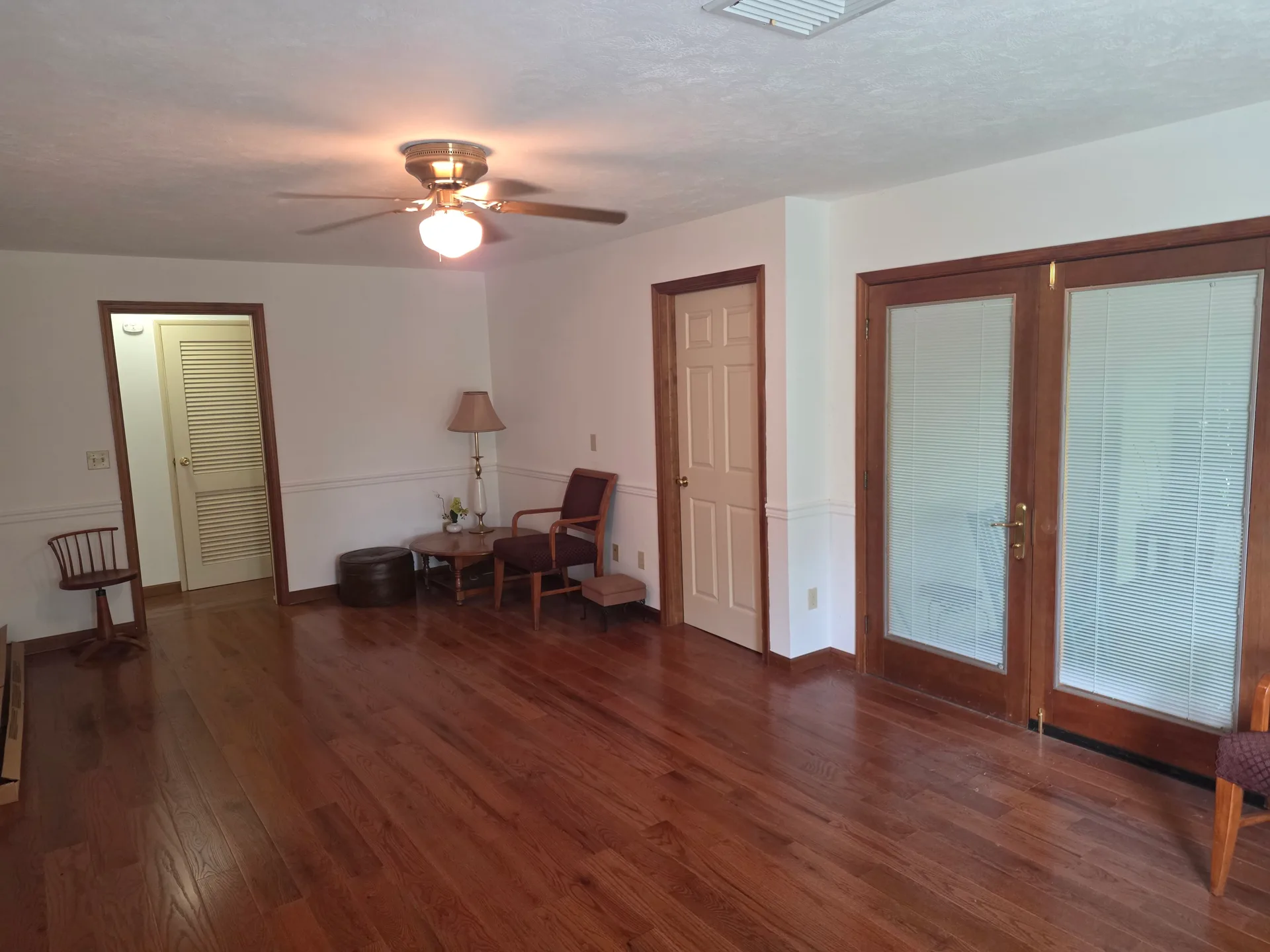 Living room with chair rail trim and dark hardwood floors