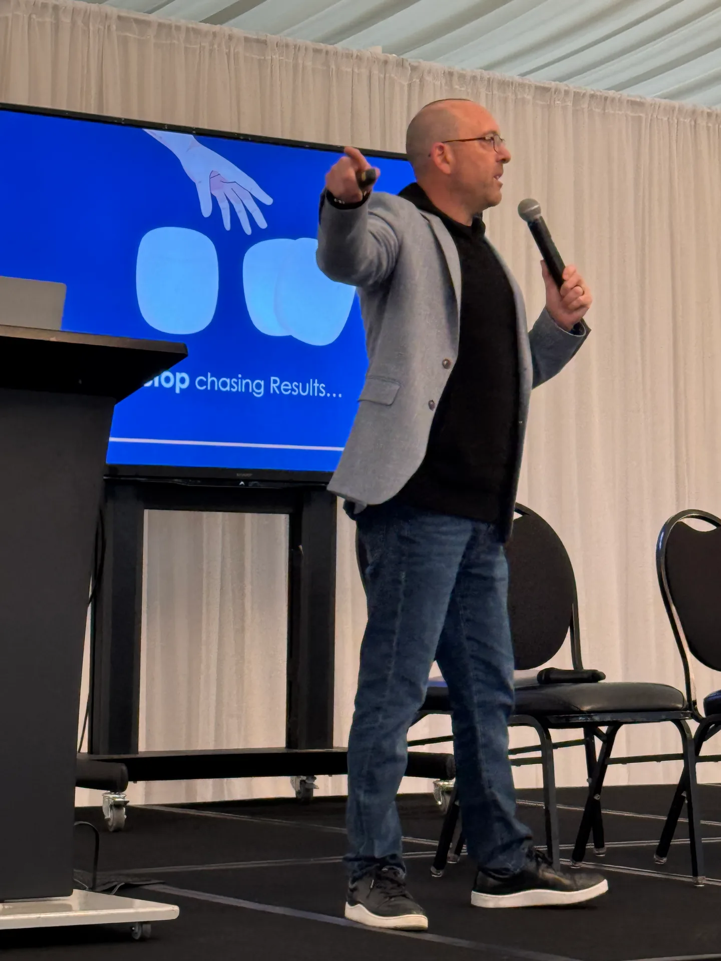 Craig Davis mid-speech on stage at Advantage Mortgage