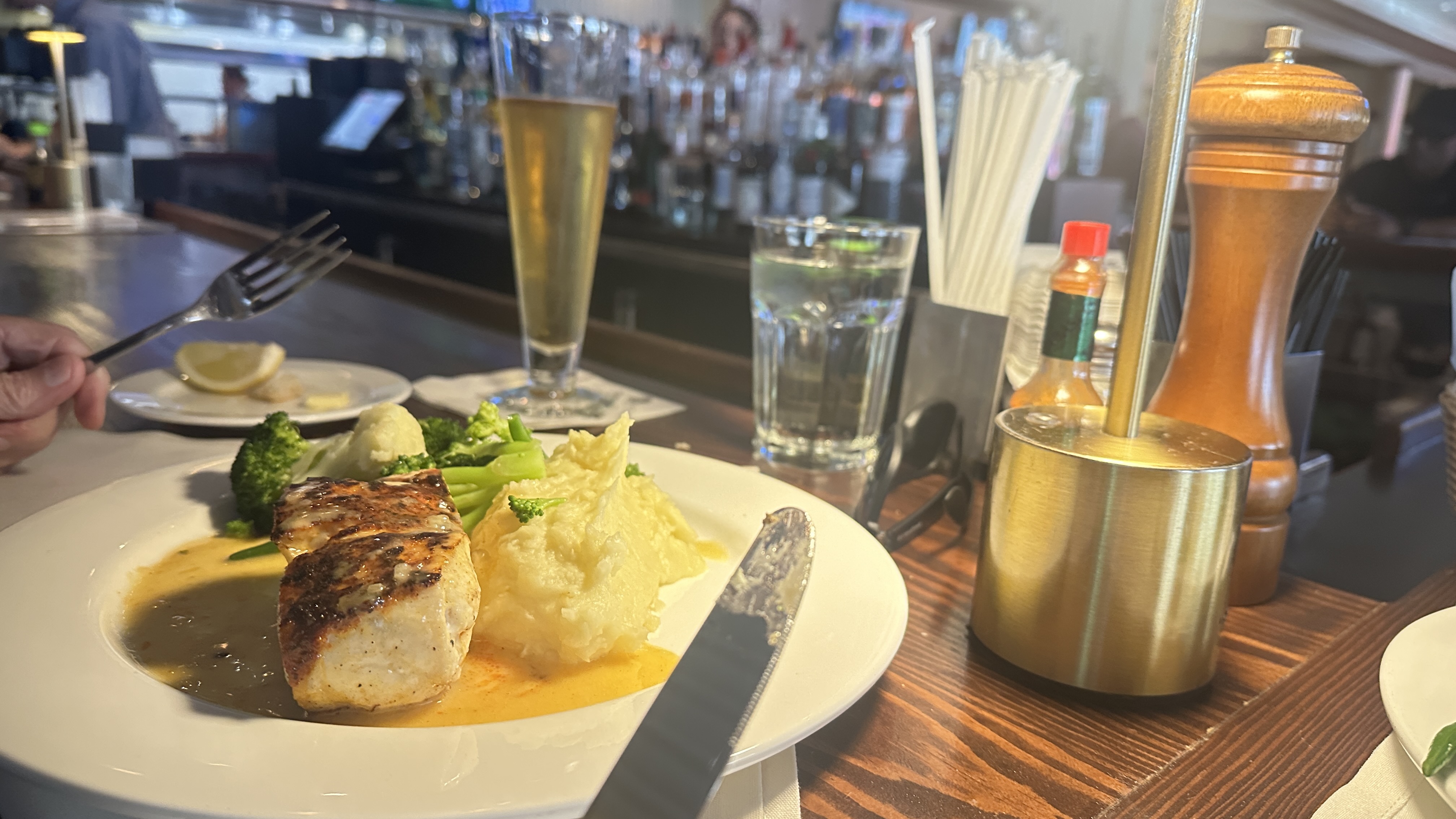 Peruvian Sea Bass with mashed potatoes and broccoli at Atlanta Fish Market, an upscale seafood restaurant in Atlanta Georgia