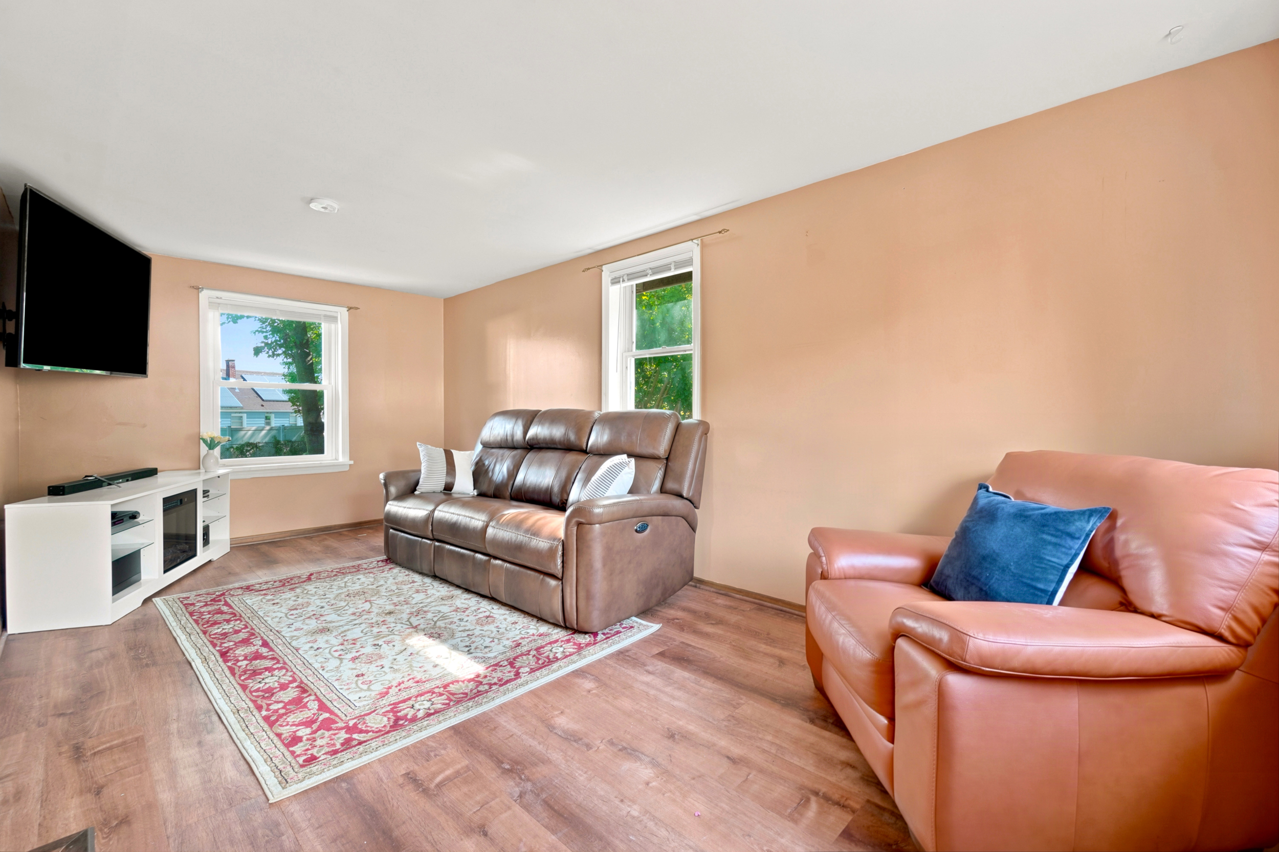 Wide view of the separate family room at 50 Heather Ln with new flooring and natural daylight