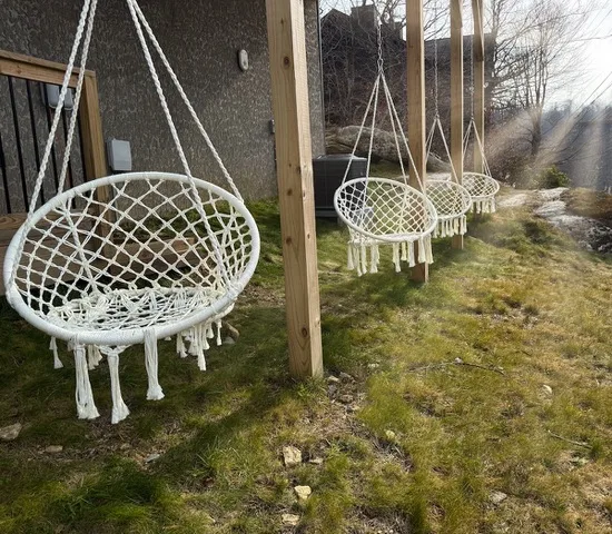 Outdoor macrame hanging swing chairs on the cabin porch