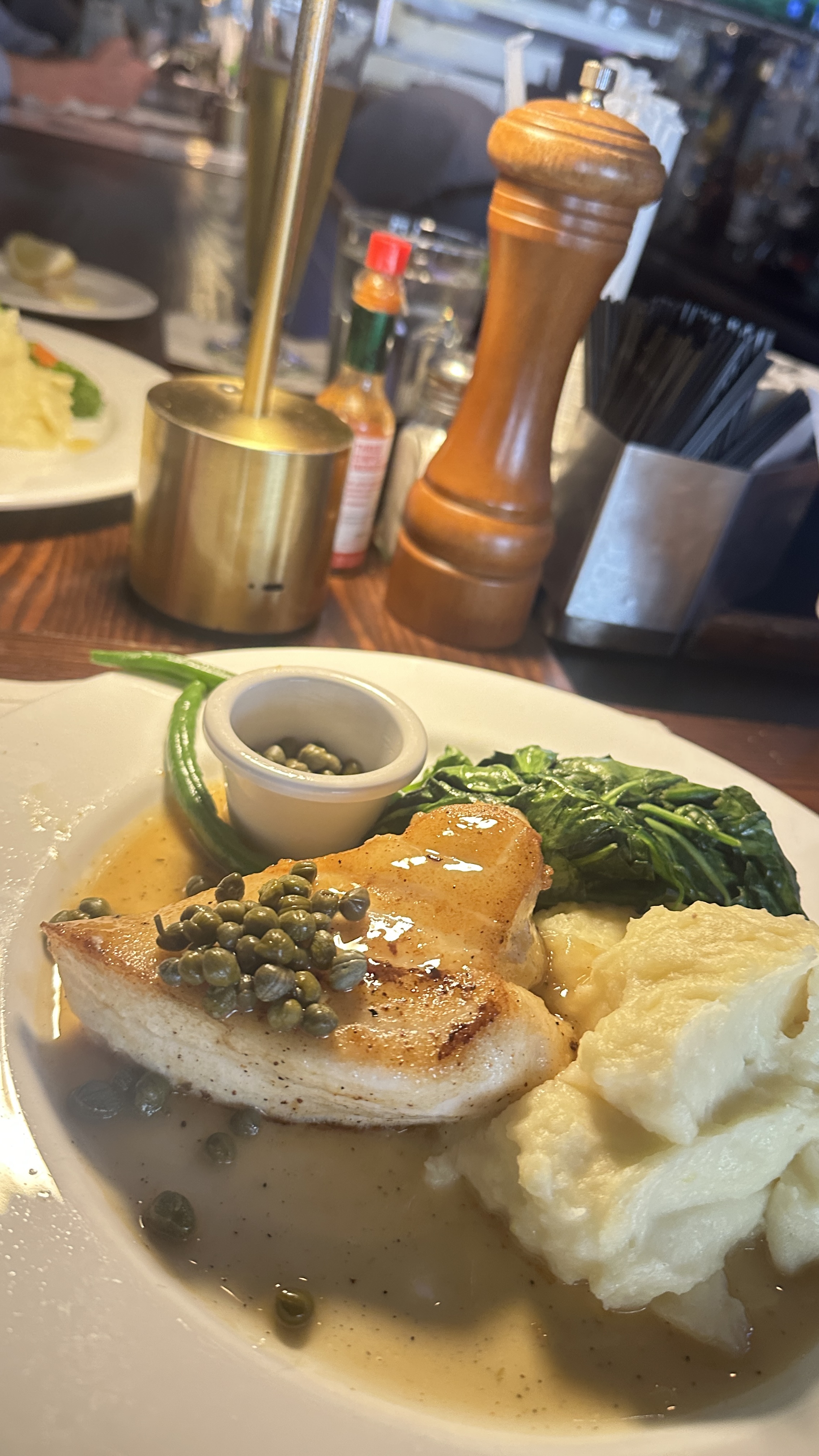 Plated seafood dish at Atlanta Fish Market, an upscale Atlanta seafood restaurant with elegant table setting