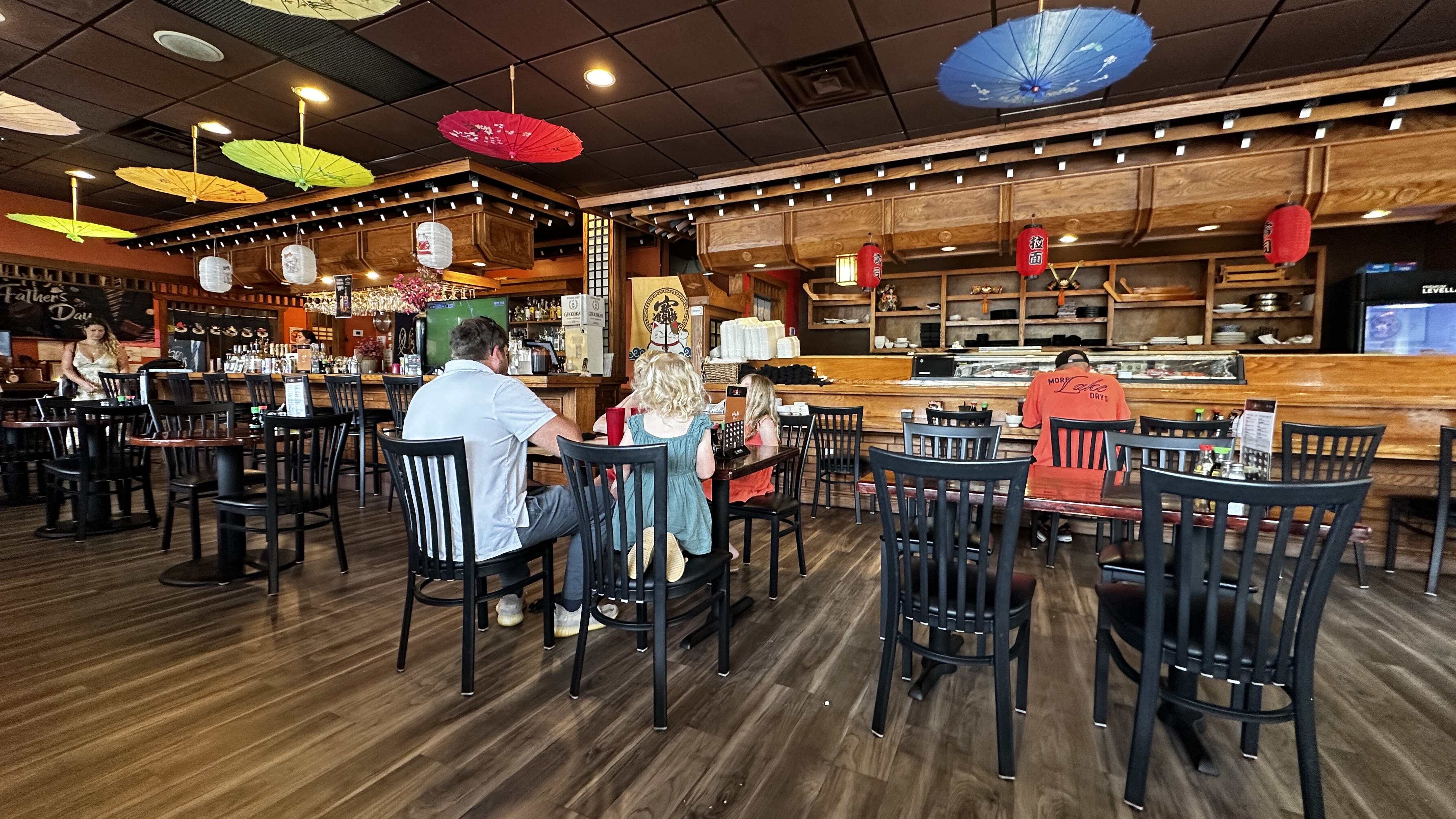Colorful paper parasols and red lanterns decorating the interior at Shogun Japanese Steak and Sushi in Flowery Branch Georgia