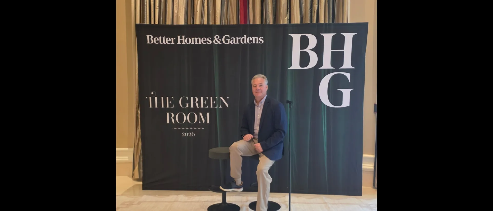 Tim Tepes seated at The Green Room backdrop at the Better Homes and Gardens Real Estate retreat in Las Vegas