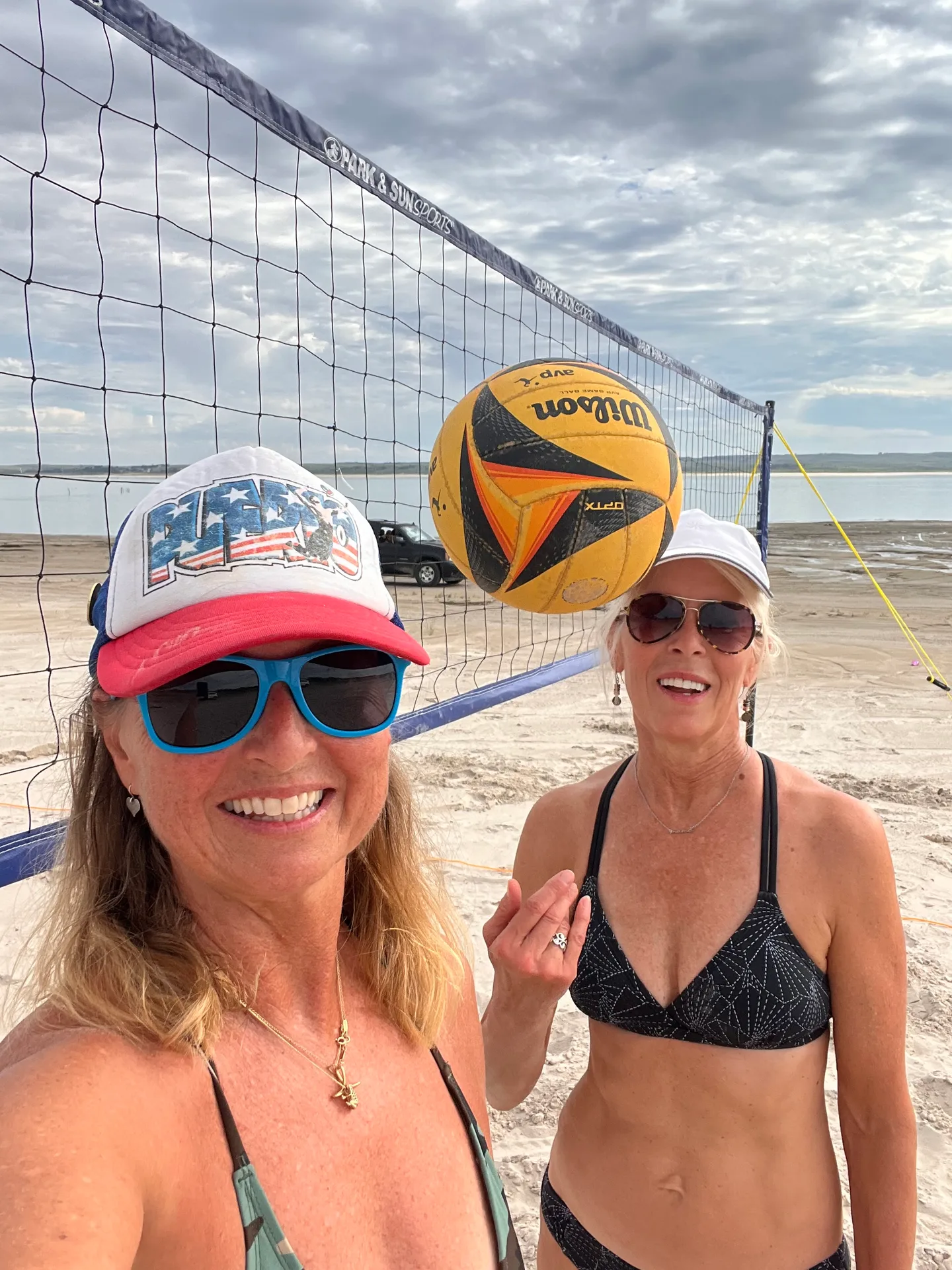 Friends relaxing on the soft white sand beach of Lake McConaughy on a bright summer day