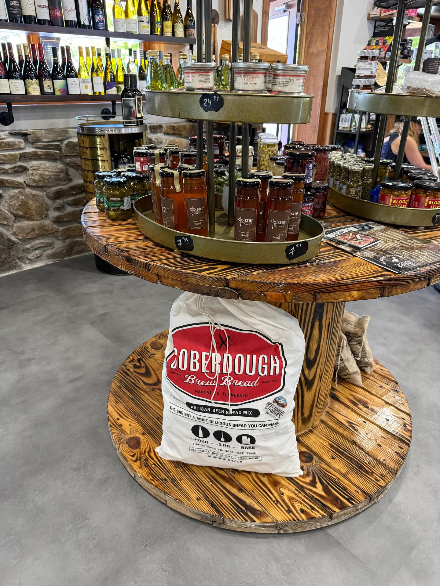 The wine shelf at Beechside Goodies with gourmet jars