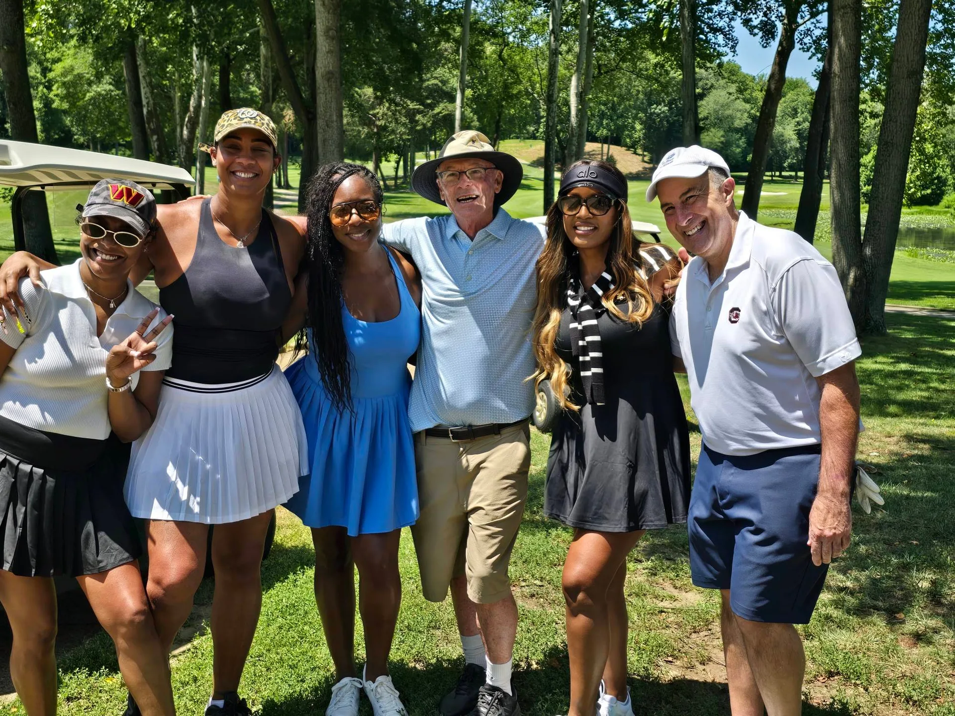 Friends enjoying a beautiful day on the course at the FORE the KIDS Golf Tournament