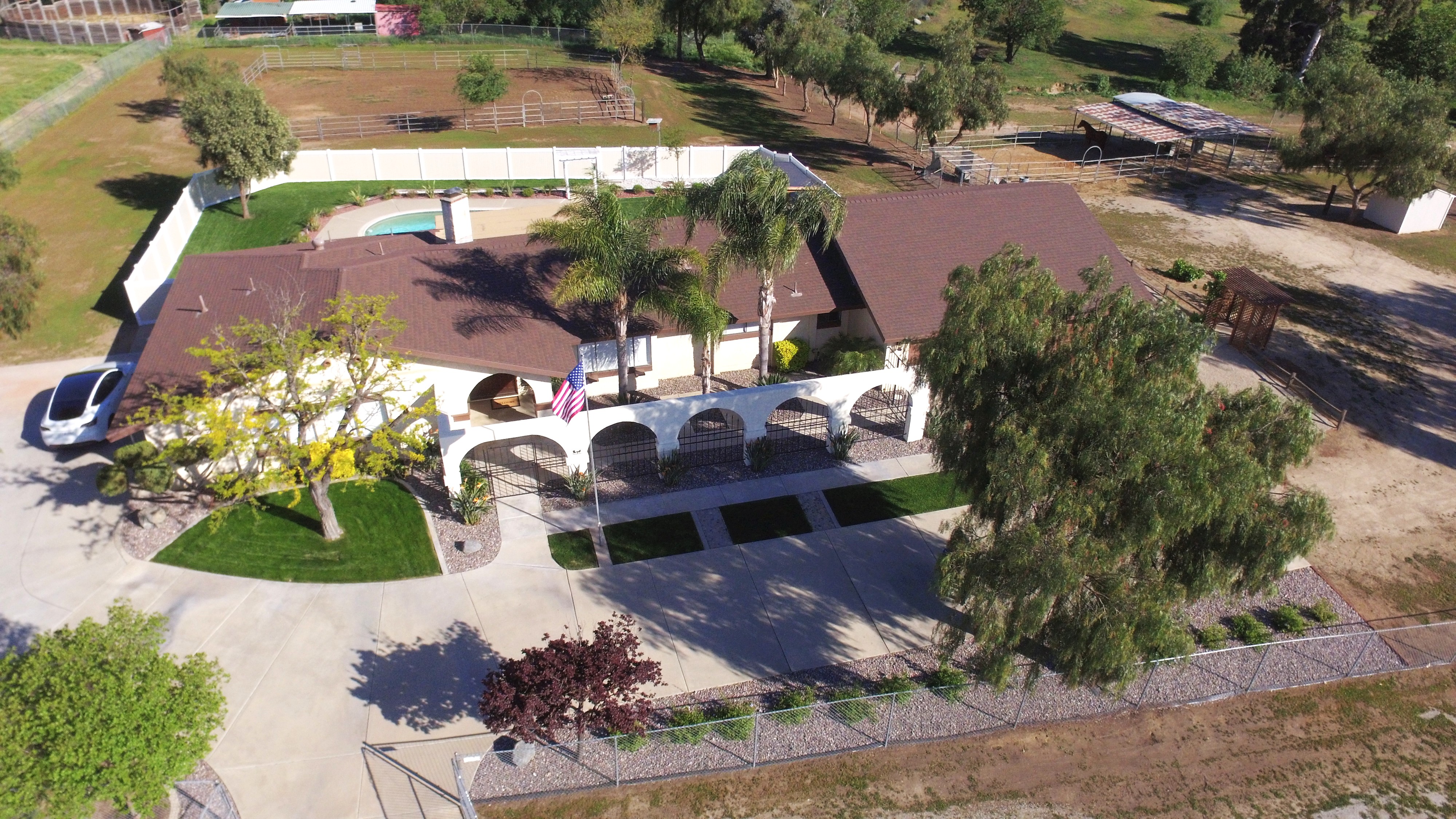 Wide-angle view of a single-story home on a large usable acreage property in Murrieta's Los Alamos Hills with mountain views at golden hour