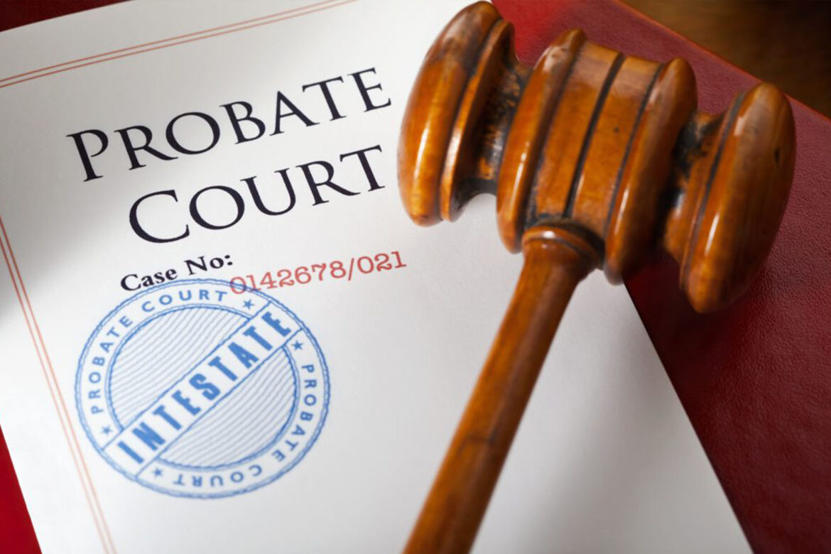 Probate court documents and legal papers on a wooden desk with gavel