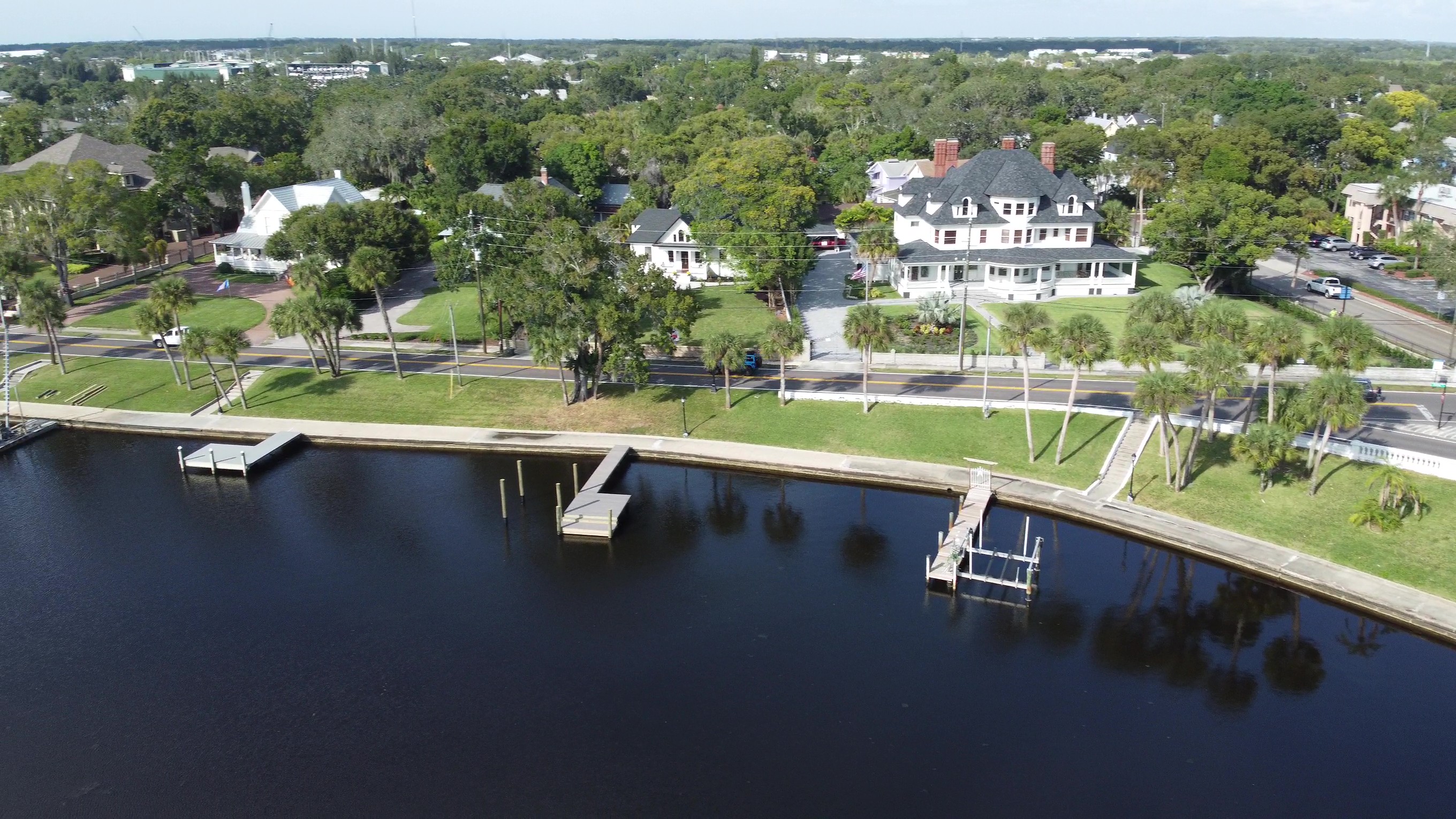 Aerial drone view of the Tarpon Bayou waterfront neighborhood in Tarpon Springs, homes lining the waterway