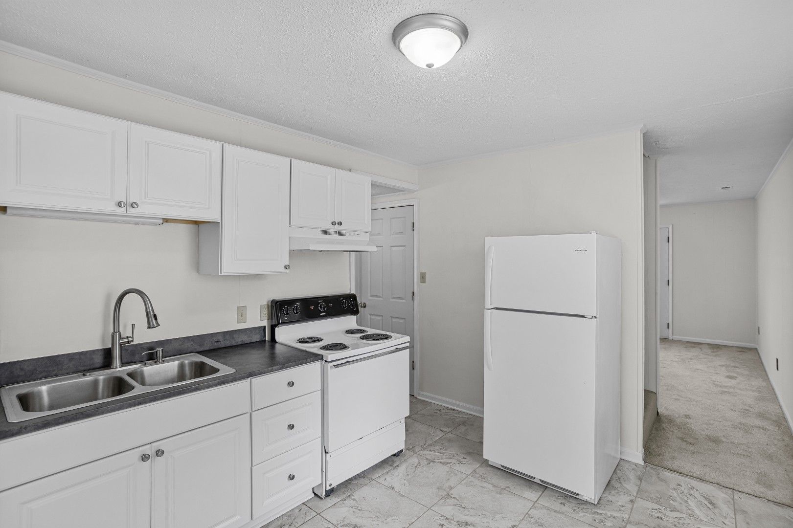 Kitchen view showing updated cabinets and appliances