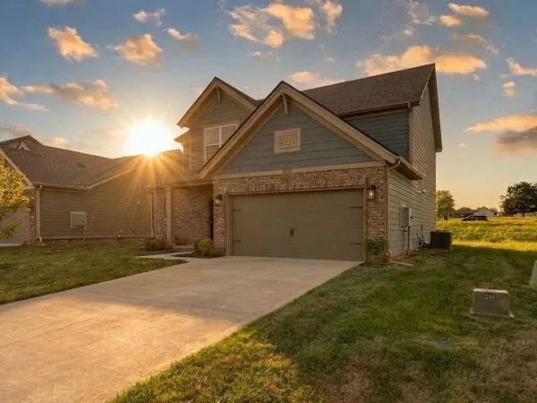 A welcoming newer suburban street of one and two story family homes with sidewalks and green lawns in the Alvaton area