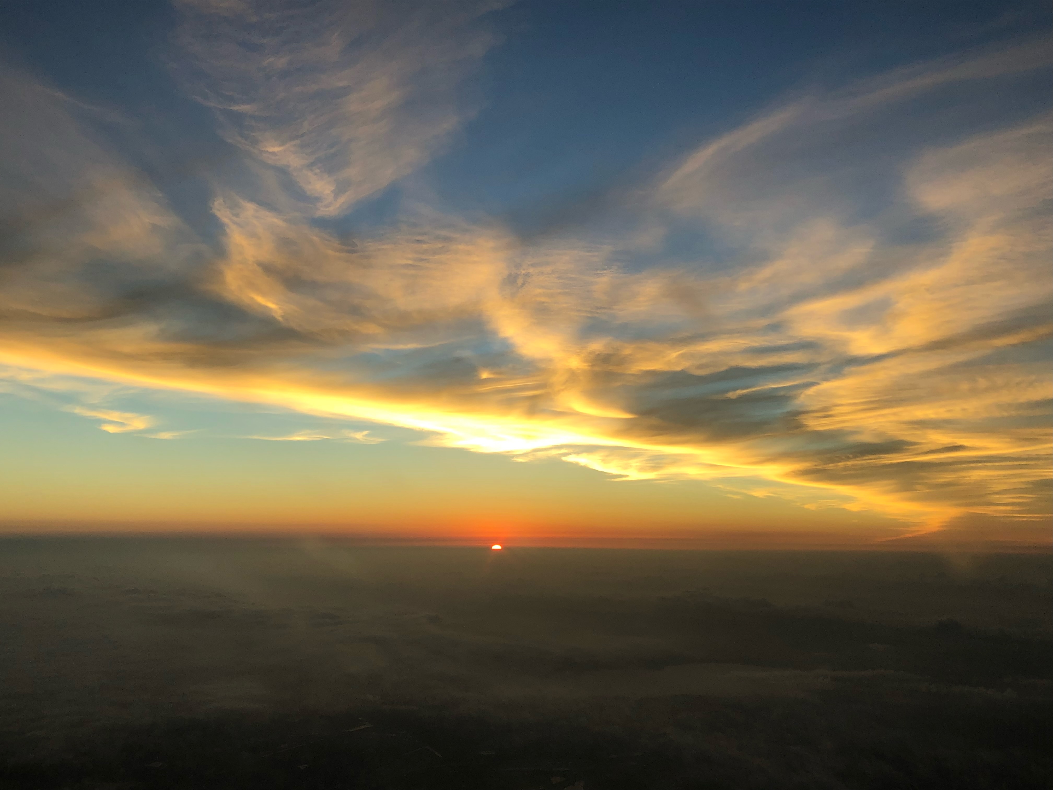 Warm sunrise over a hazy horizon, a new day for pilots considering their next move