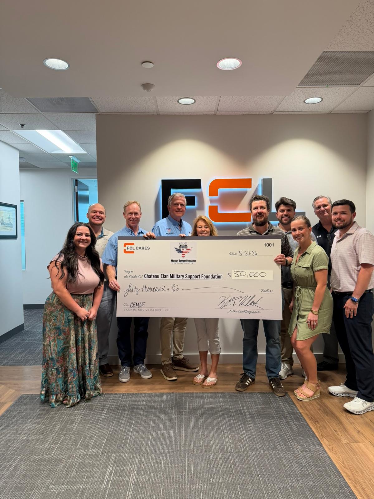 Foundation leaders and community members presenting an oversized donation check to benefit North Georgia veterans