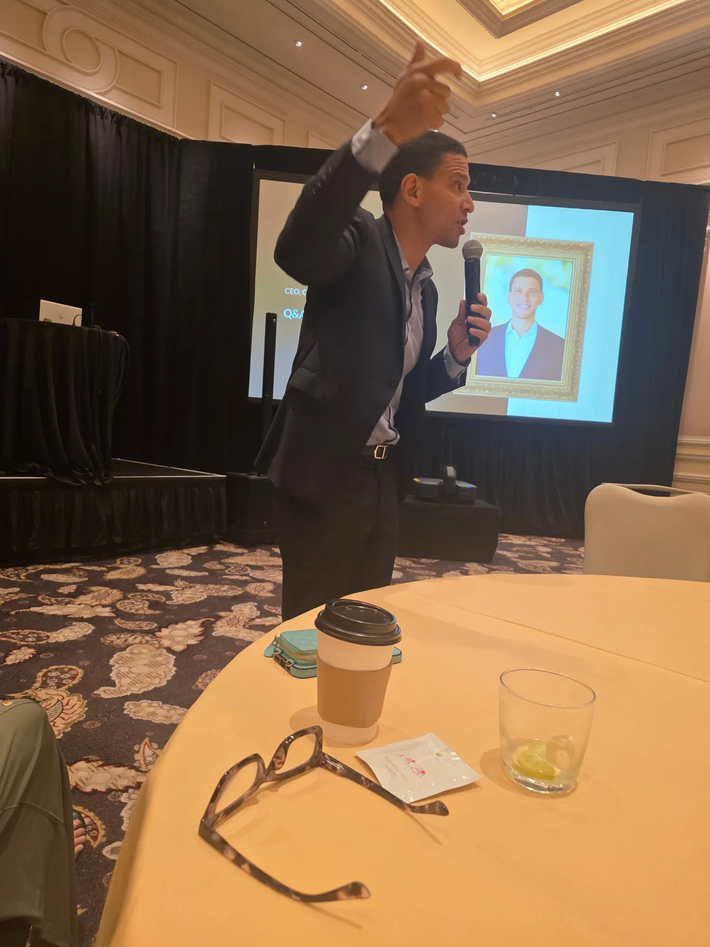A speaker leads a question-and-answer session from the podium at the Better Homes and Gardens Real Estate retreat