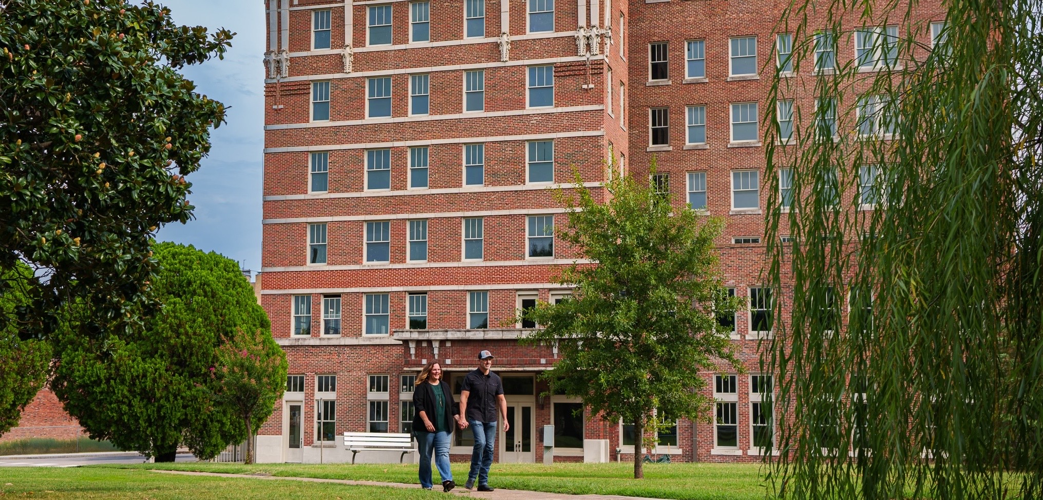 Shannon and Scott Miles walking in front of a historic brick building in Northeast Texas