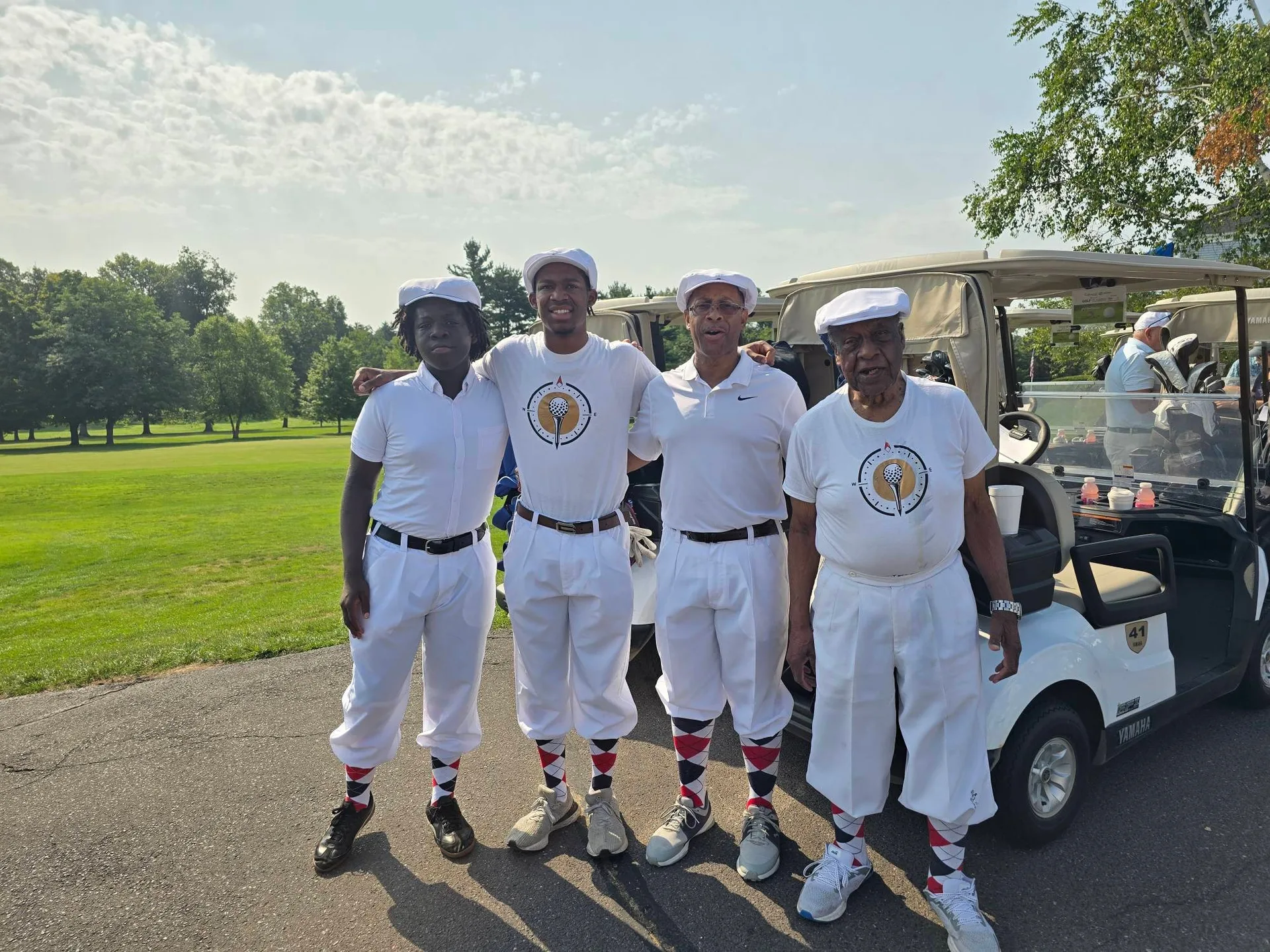The full foursome in matching white knickerbocker-style outfits at the Calcagni Golf Classic