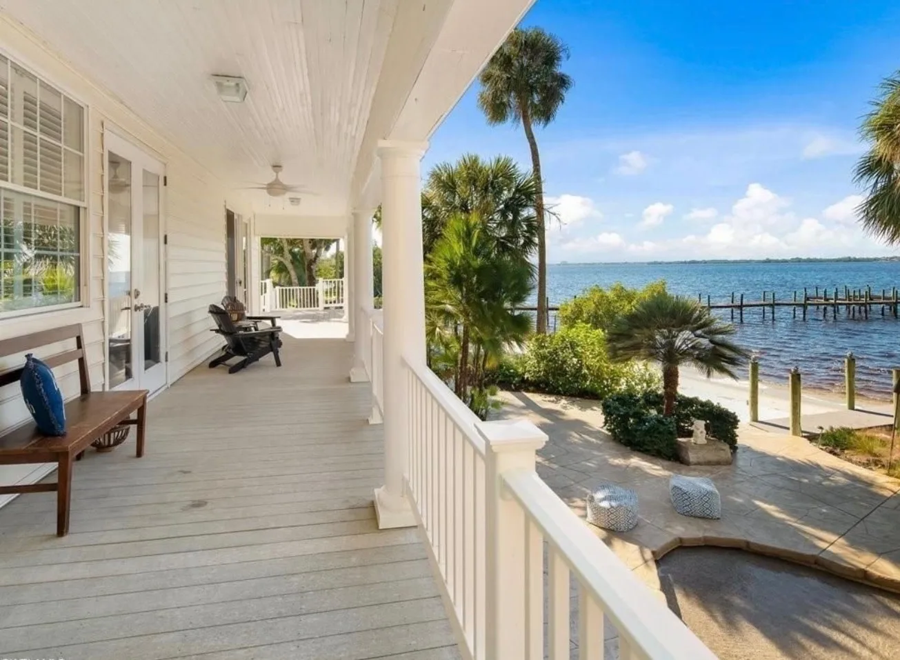 Wrap-around porch overlooking the waterfront with dock visible at 100 Fairview Ave, Fort Myers
