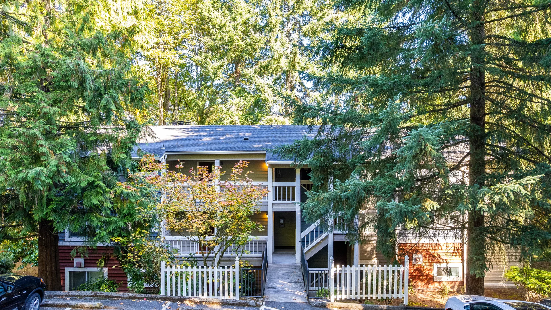 The entrance of the Horizon Village condo building in Bellevue, with a central entrance walkway and a staircase with white railings