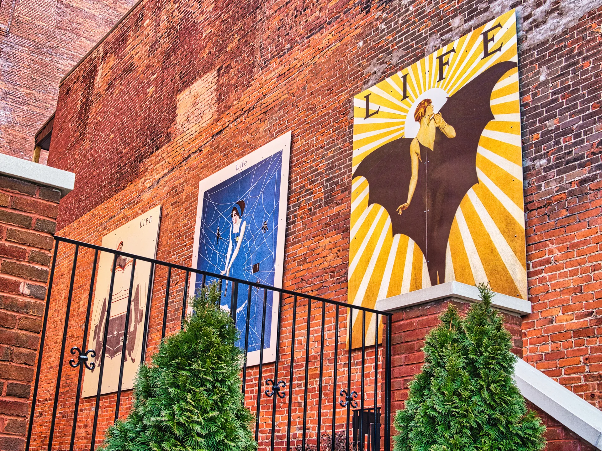 Vintage LIFE magazine posters on a brick wall