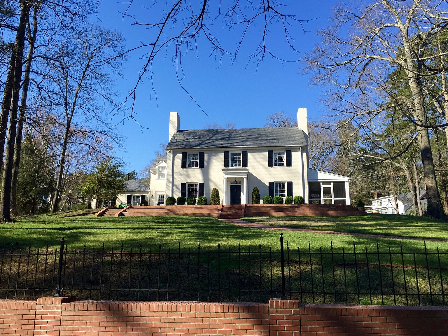 Classic house in the Forest Hills neighborhood of Durham, North Carolina with a brick facade and front lawn